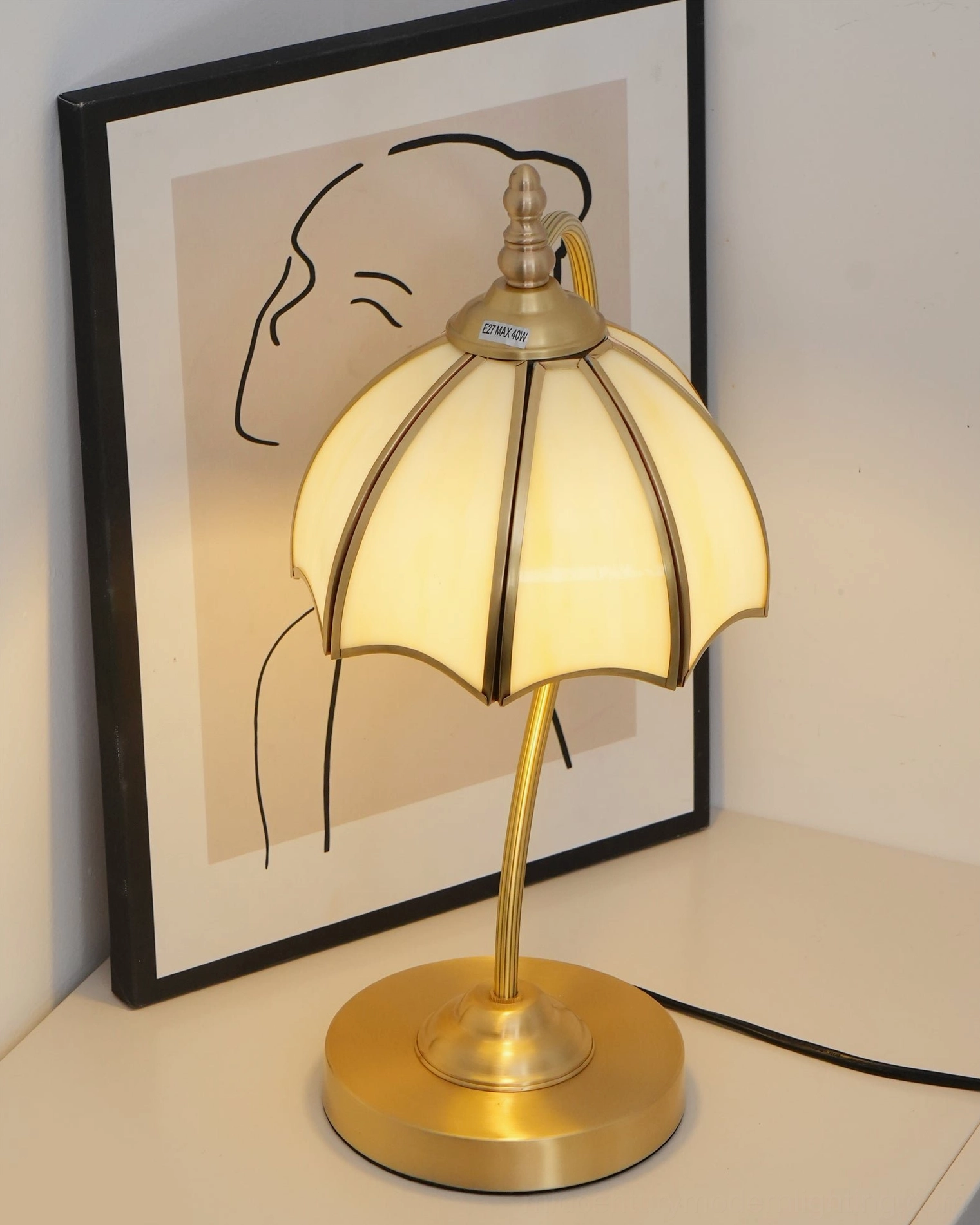 Umbrella shaped table lamp with premium brass frame and frosted glass panels detail