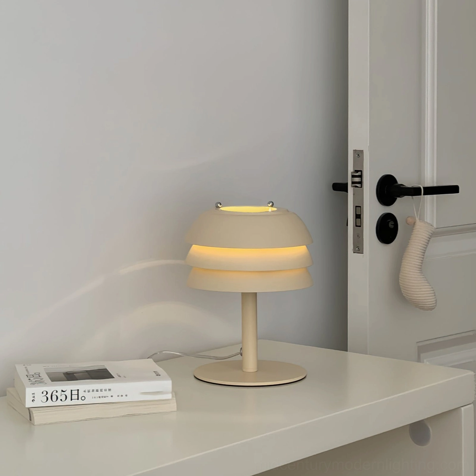 Valencia tiered lamp with Edison bulb option showing warm vintage amber glow, retro mid-century aesthetic