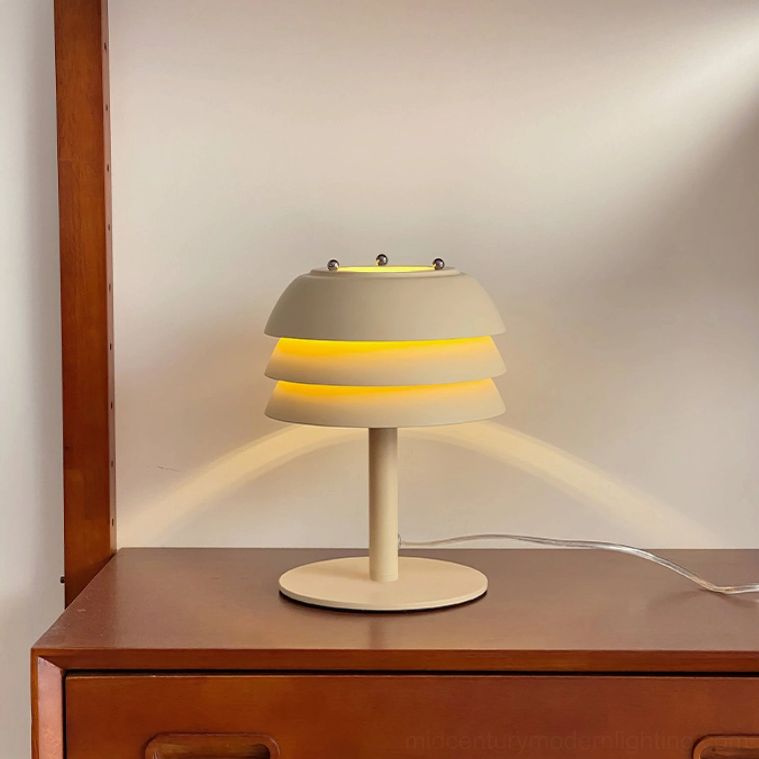 Valencia table lamp geometric tiered silhouette on dark surface, sculptural mid-century modern design form