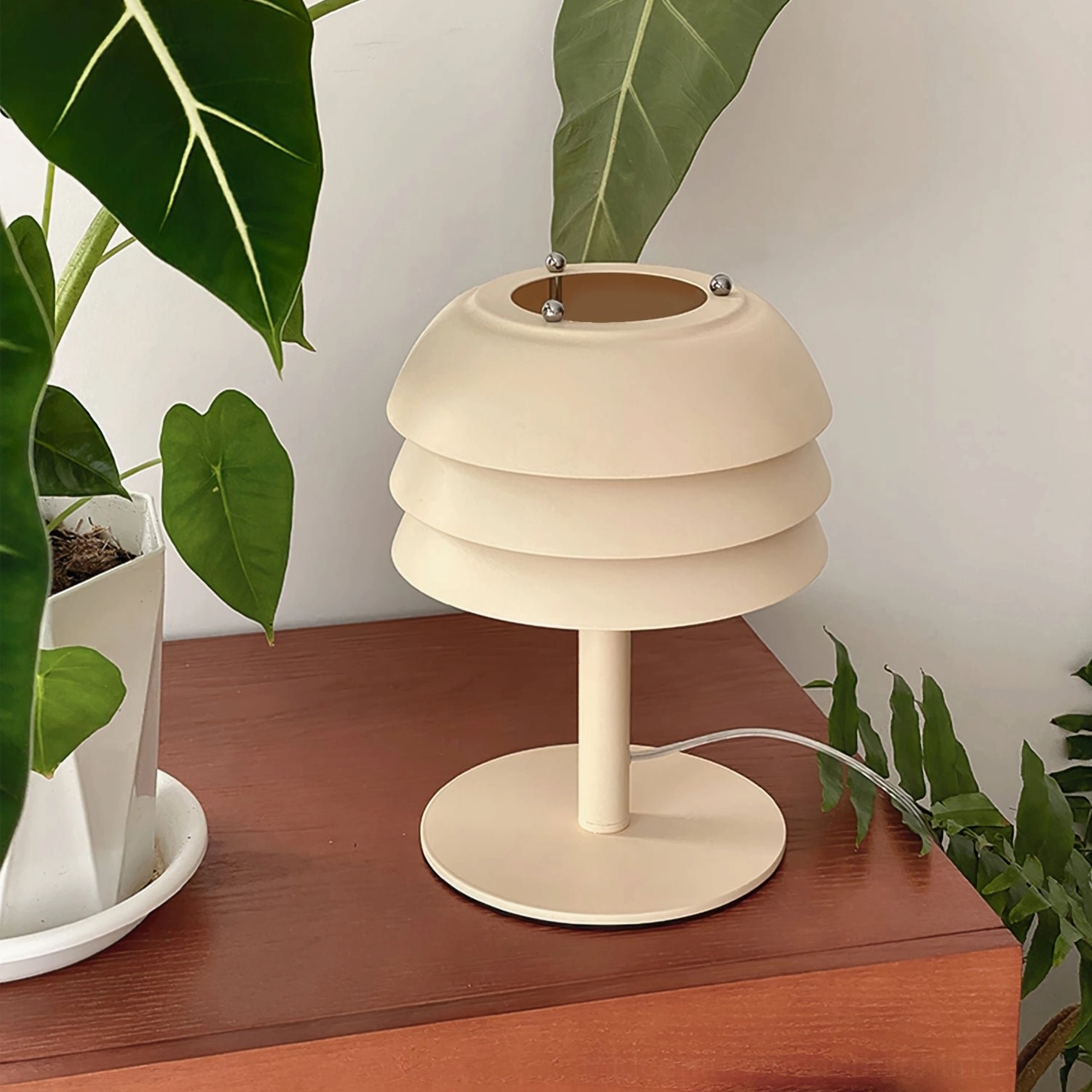 Valencia mid-century modern tiered table lamp angled three-quarter view, geometric metal form with cream finish