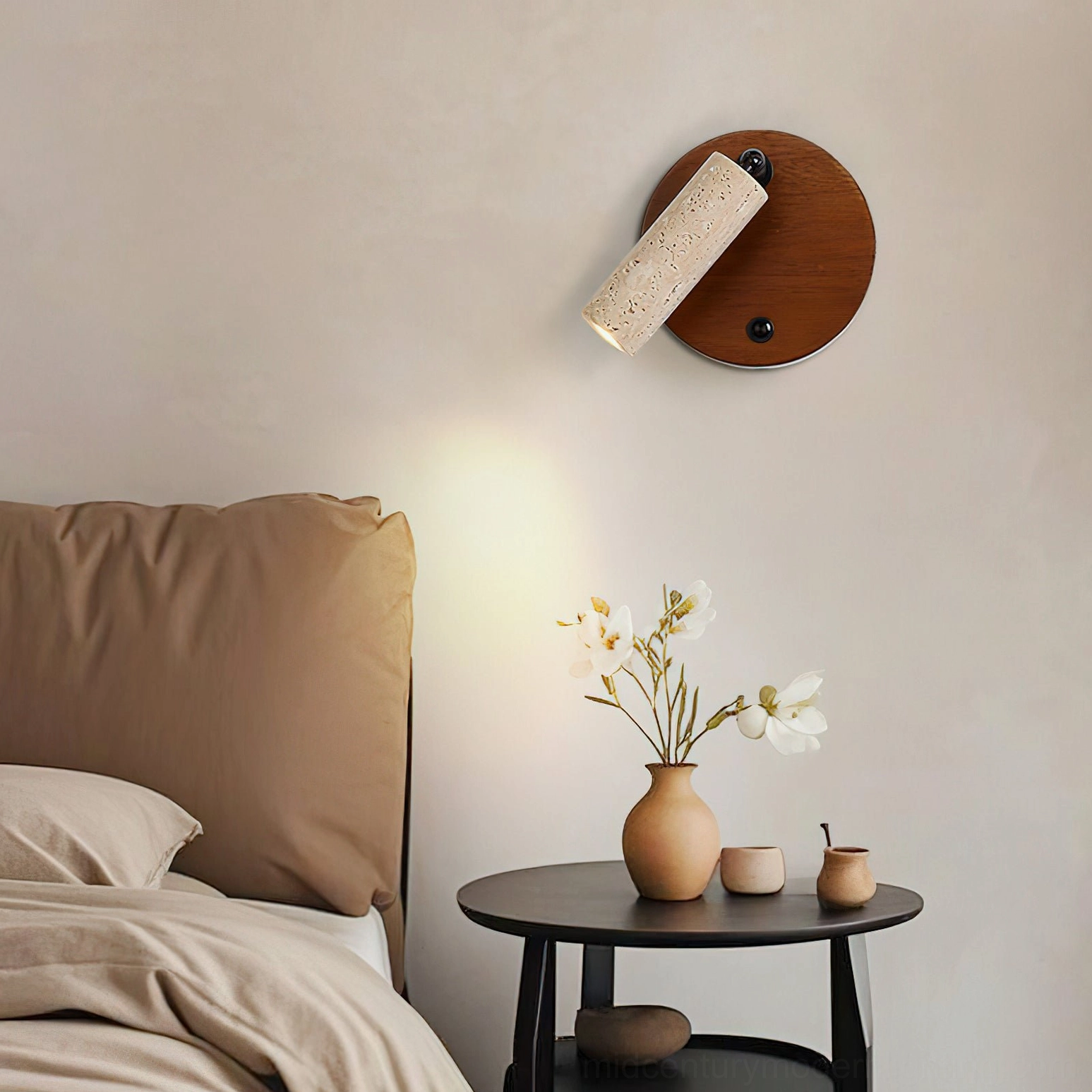 Veda wall sconce mounted in minimalist bedroom with dark wood base and black metal swivel joint detail