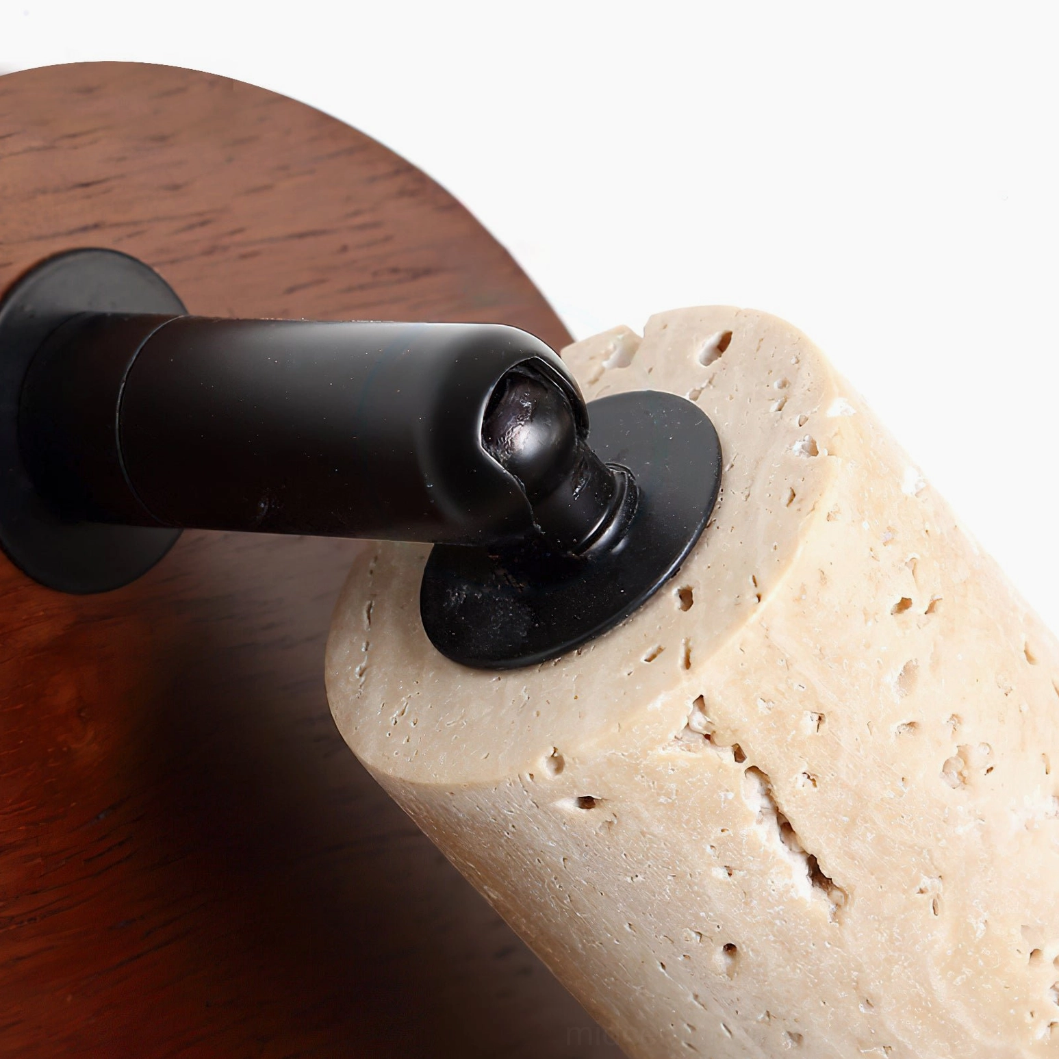 Veda travertine wall sconce extreme close-up detail of black metal swivel joint and dense stone pores