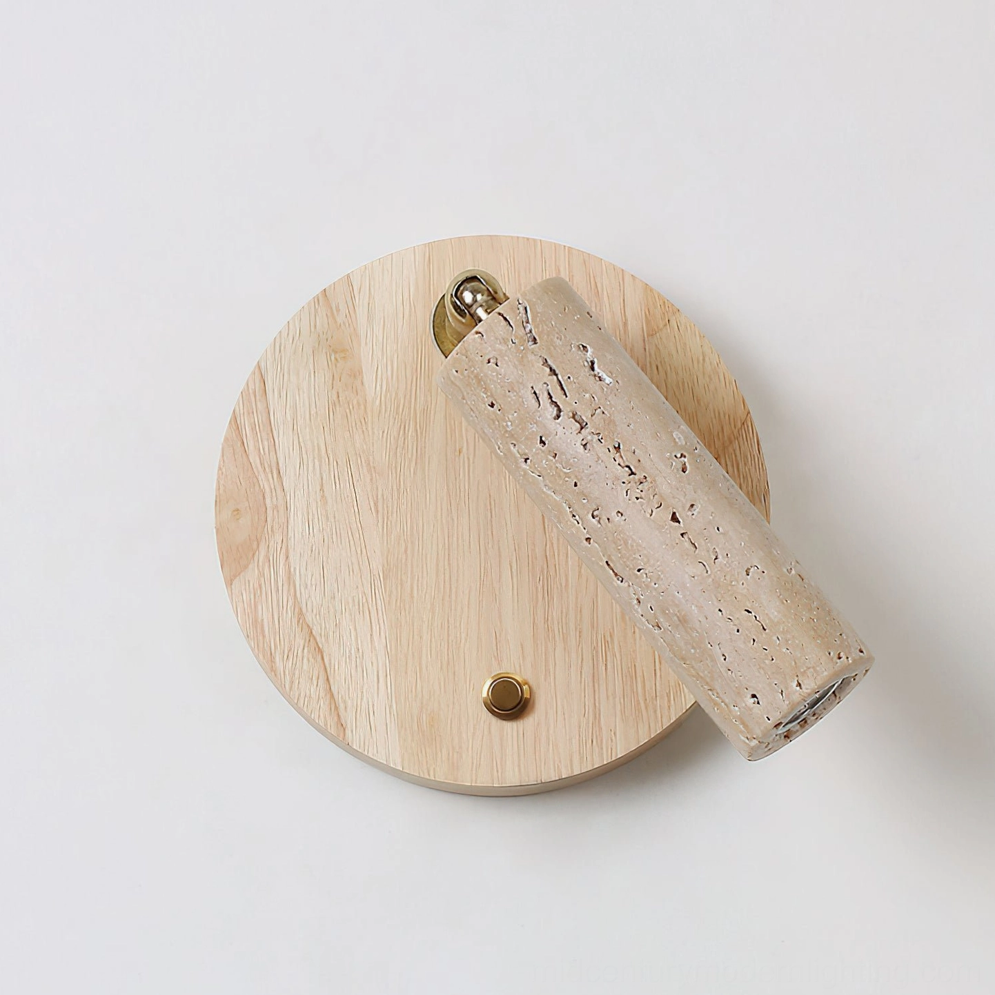 Veda wall lamp side view with light wood backplate and illuminated travertine stone cylinder