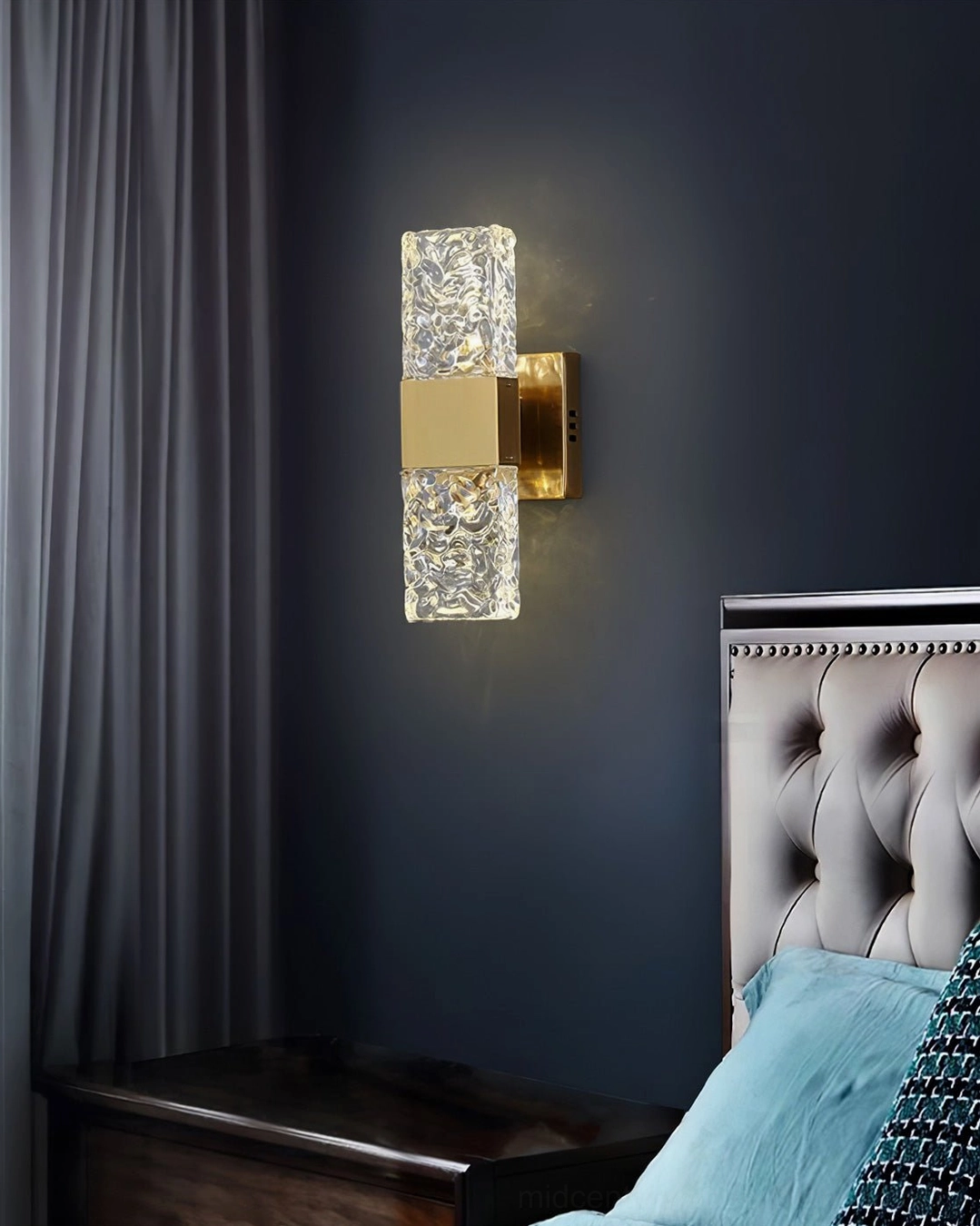 Vega brass gold wall sconce with rippled glass on dark blue accent wall, luxury bedroom decor