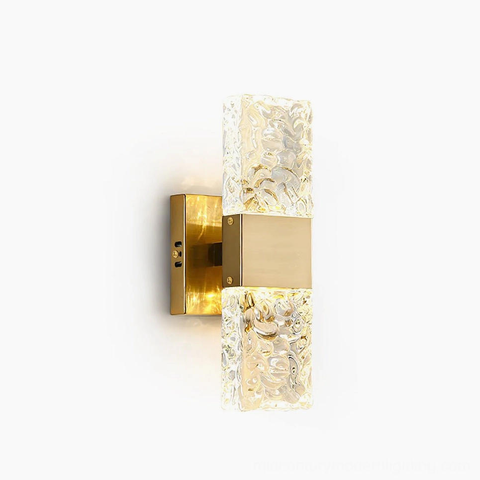Vega gold wall sconce with textured clear glass diffuser, frontal studio view showcasing mid-century modern design