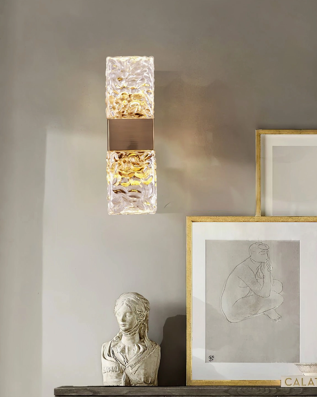 Close-up detail of Vega textured glass diffuser and brass gold finish with interior decor backdrop