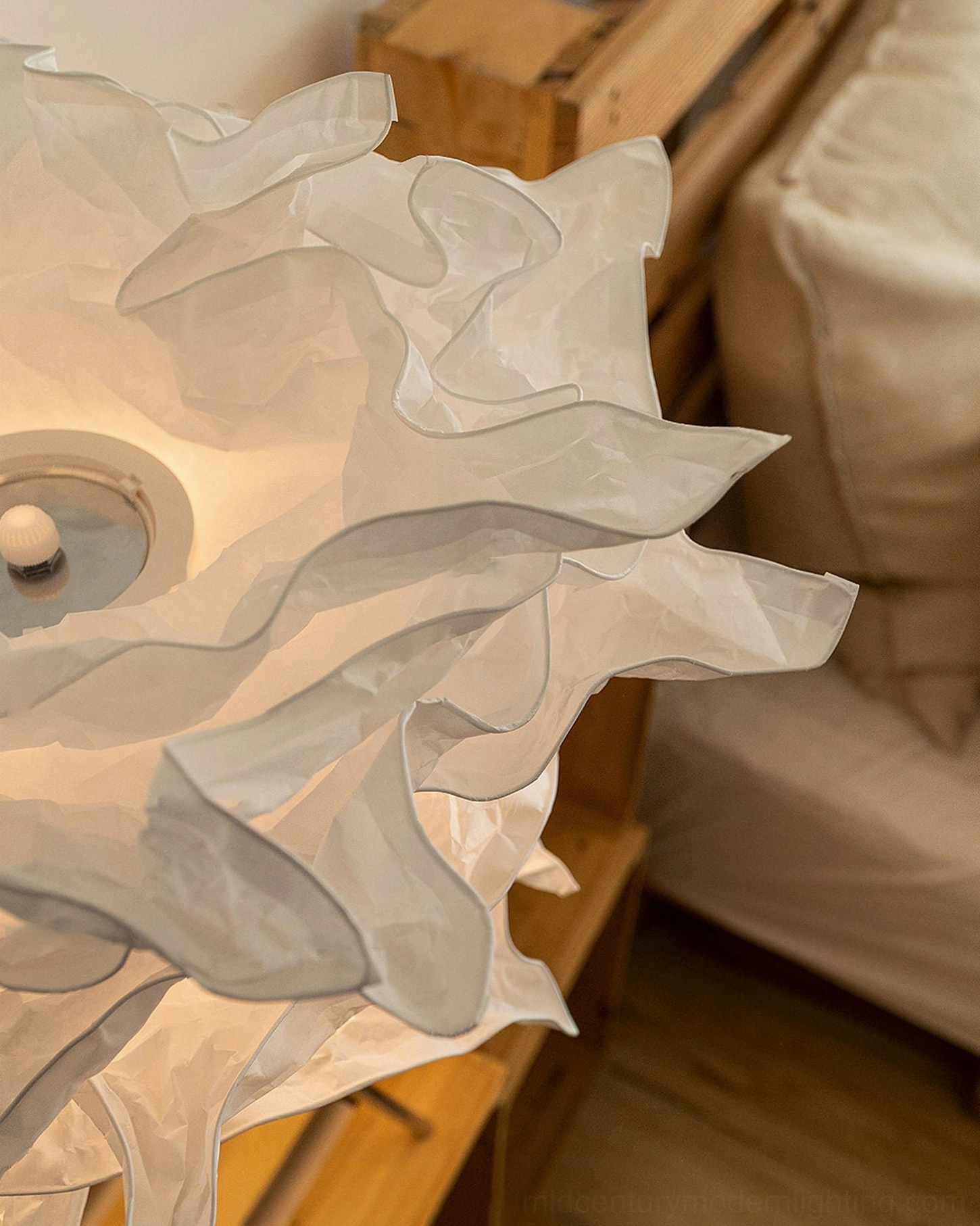 Extreme close-up texture detail of Veli mulberry paper shade showing artisanal layered ruffled fabric and soft translucent material