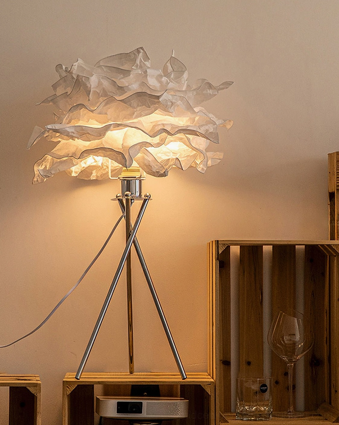 Veli artisanal paper table lamp front view with illuminated layered ruffled mulberry paper shade creating soft diffused light