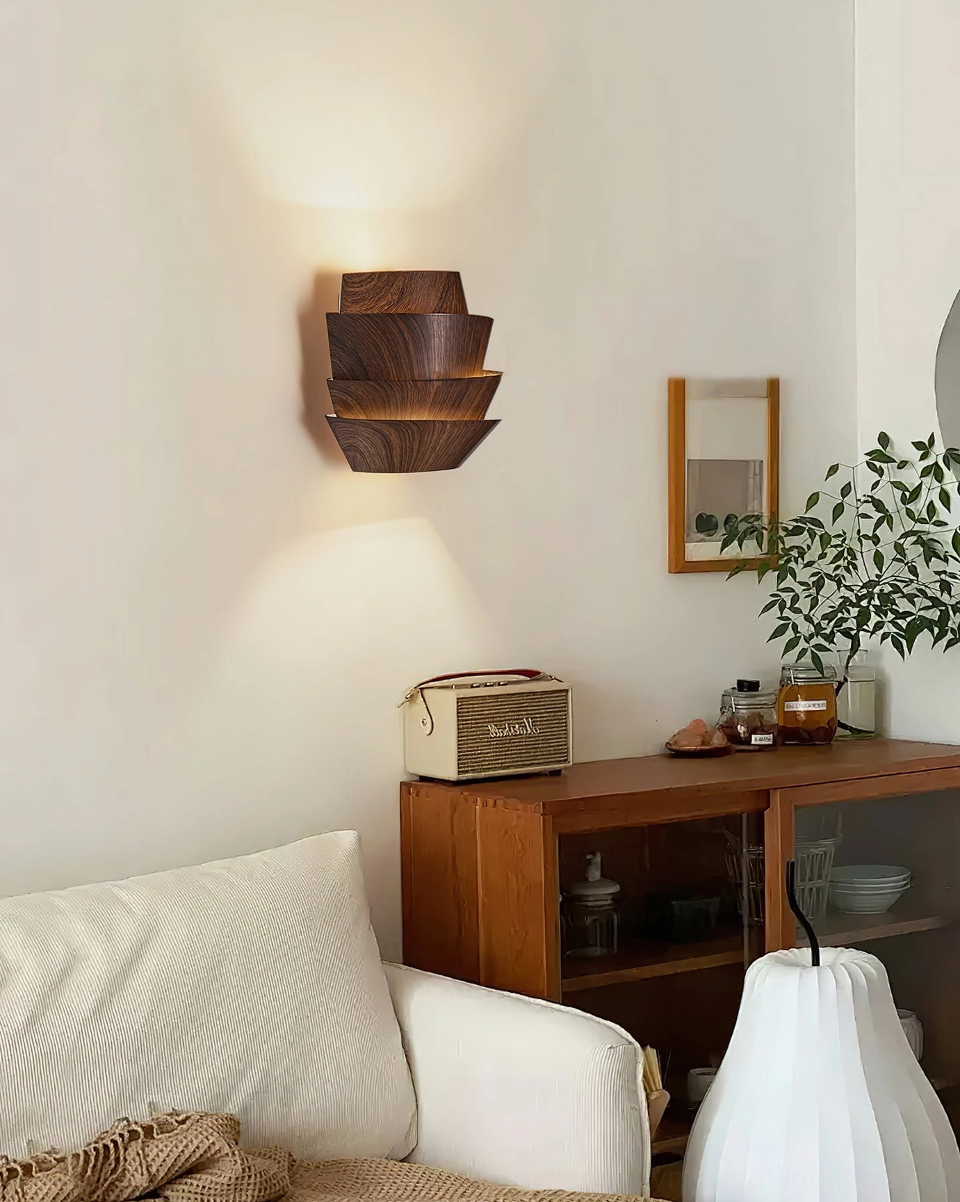 Veneer wood grain wall lamp in minimalist living room with wooden cabinet and fabric sofa decor