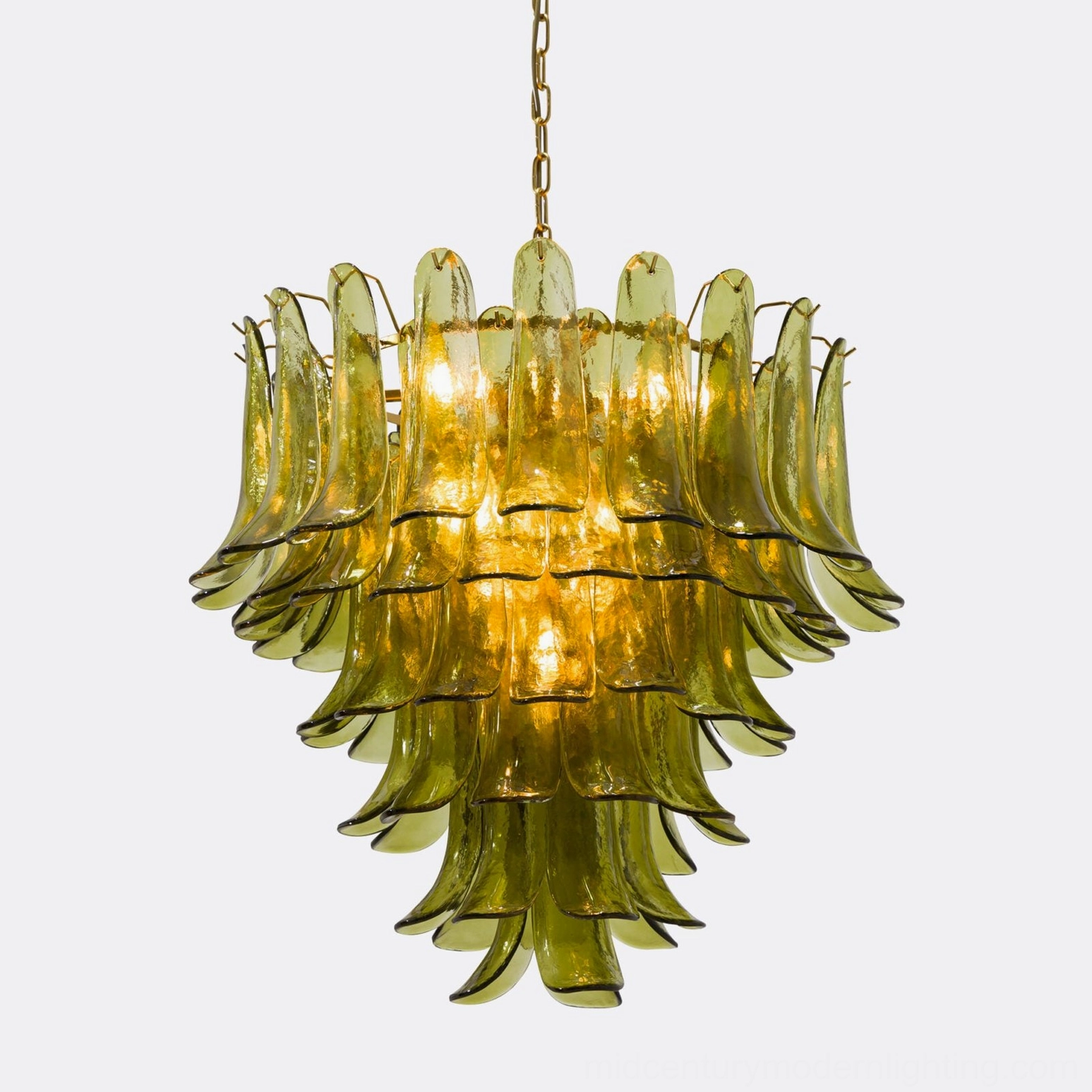 Front view of illuminated Verdant Petalo showing bright central bulbs and warm light diffusion through olive green glass
