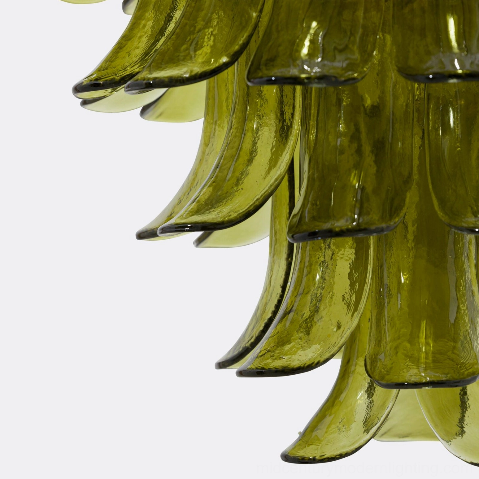 Angled close-up of thick translucent olive glass petal showing smooth wavy contours and light-diffusing properties