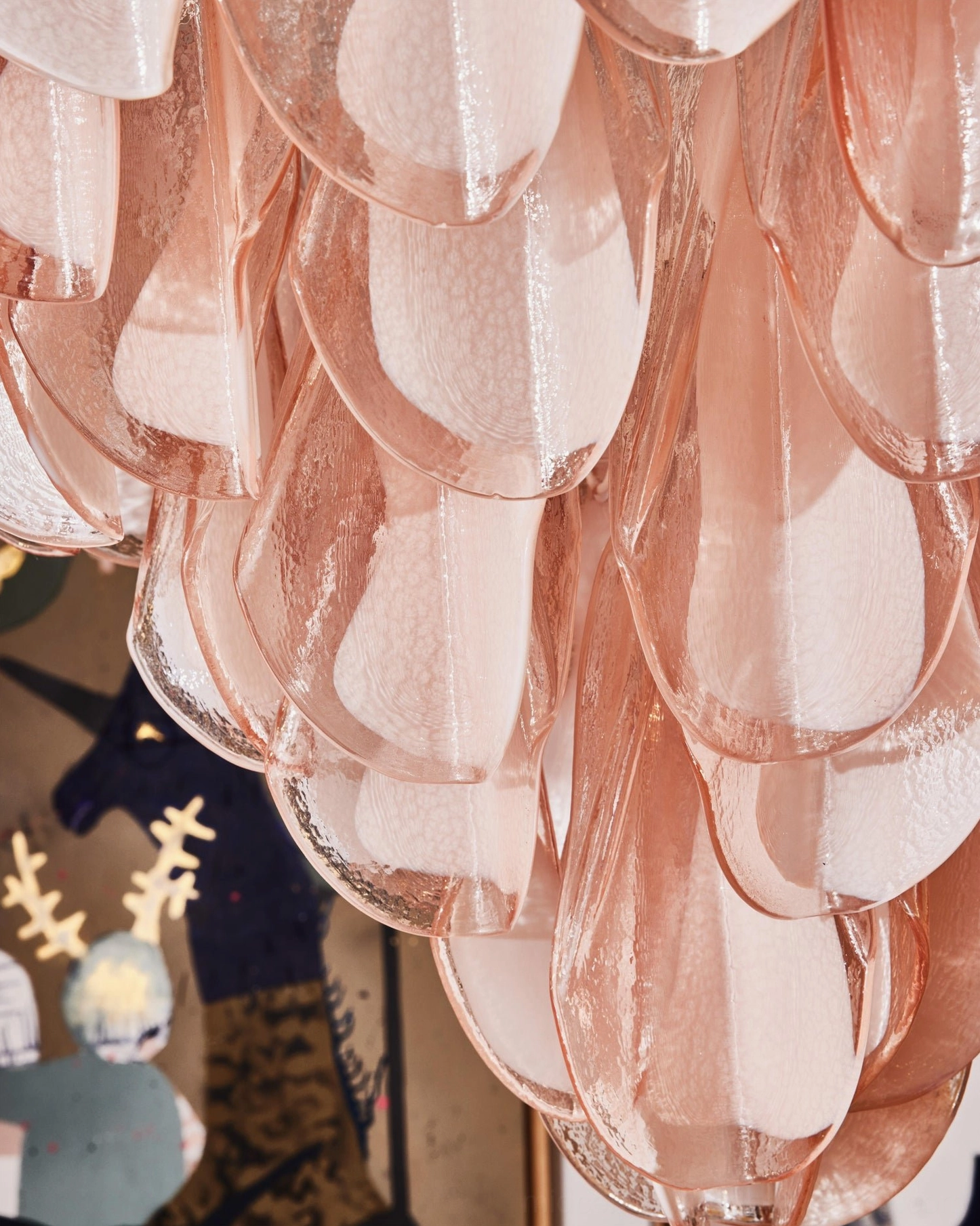 Close-up macro detail of Verona pink Murano glass petal, translucent blush tone with glossy organic texture