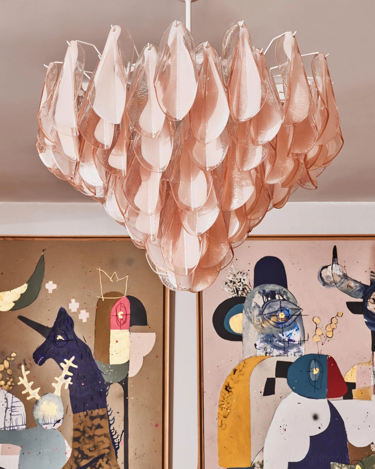 Pink hand-blown glass chandelier low angle view, translucent petal layering detail with white suspension rod