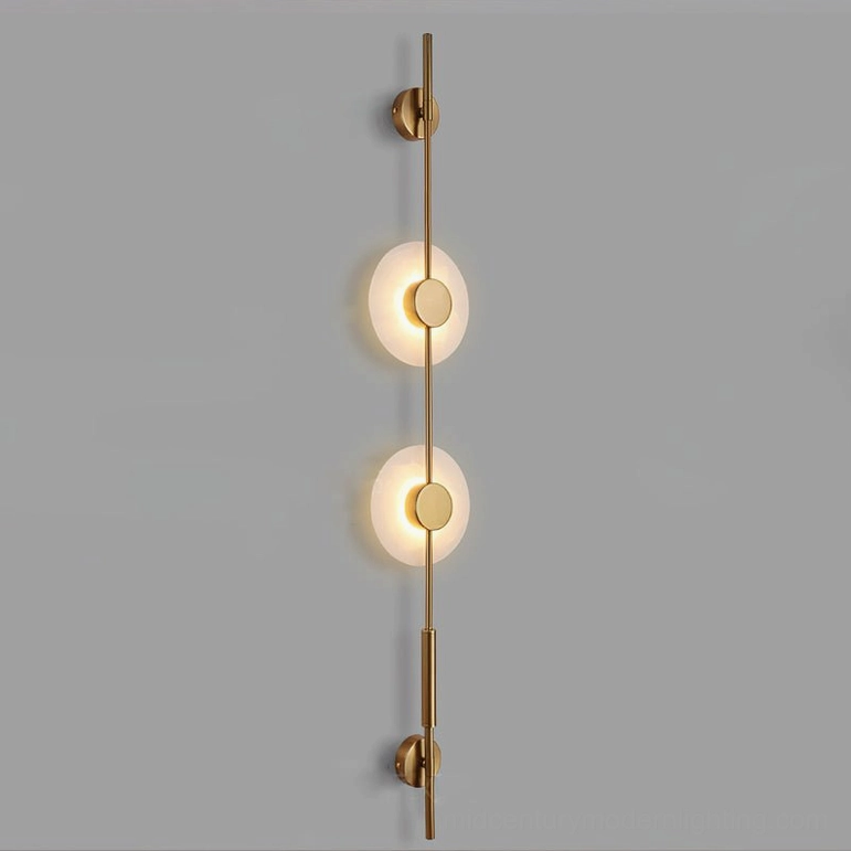 Two-light vertical alabaster wall lamp in warm gold finish showcasing mid-century modern minimalist design on studio background