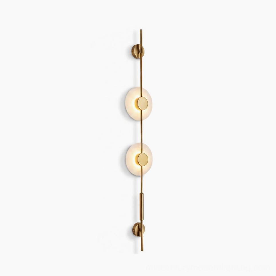 Vertical alabaster wall lamp with two frosted glass discs and brass gold metallic frame on studio white background, front view