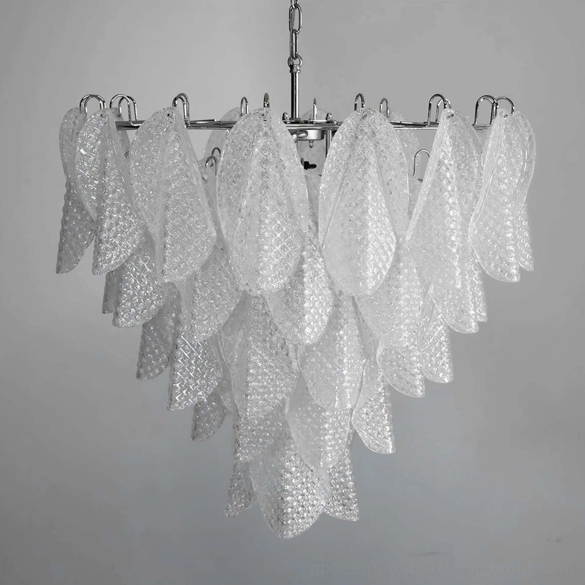Vianna ripple glass chandelier illuminated showing warm luminous glow and glass light refraction