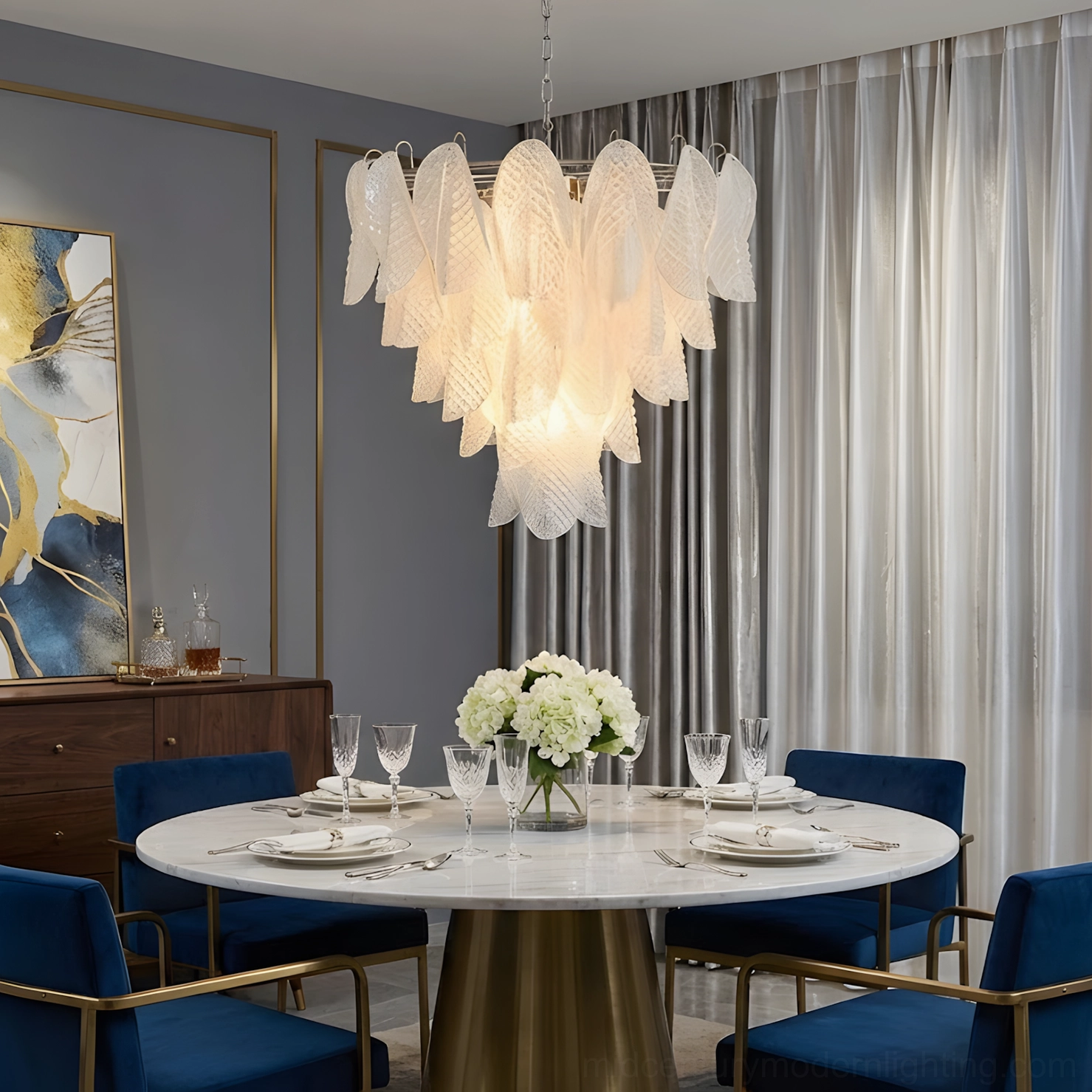 Ripple glass chandelier in minimalist modern dining room with blue velvet chairs and round metal table