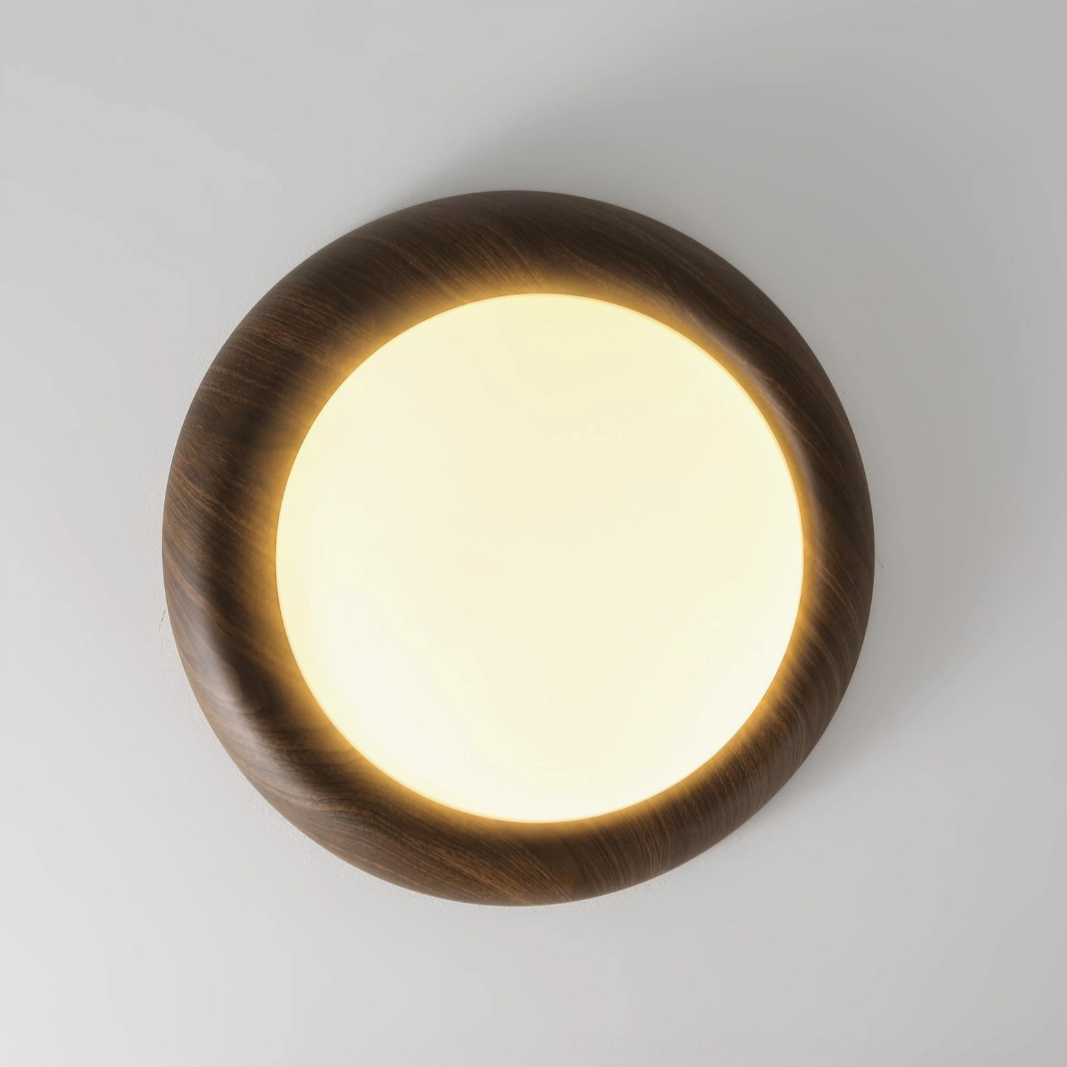 Close-up of Vikaey ceiling light with glowing frosted acrylic diffuser and dark wood frame detail