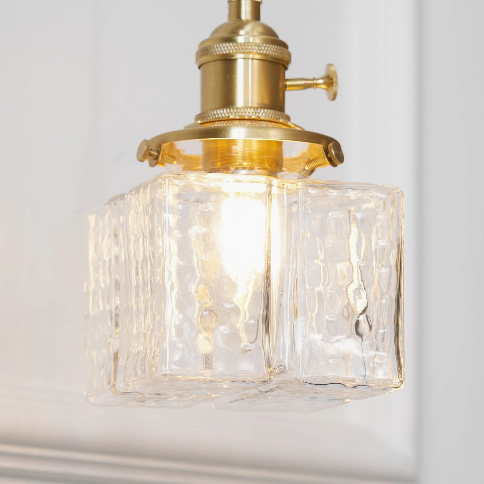 Vintage brass wall sconce with rippled glass ambient bedroom lighting solution