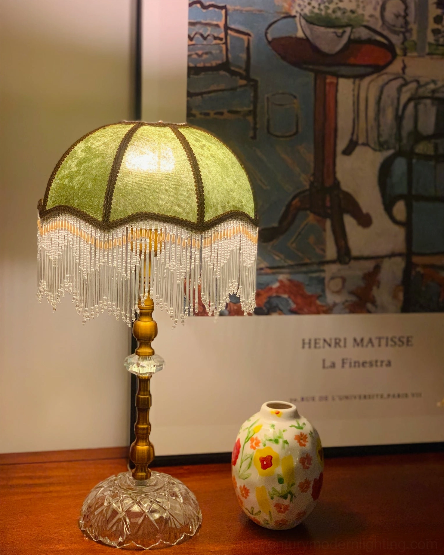 Vintage-inspired fringed table lamp with hand-cut crystal base and soft fabric glow
