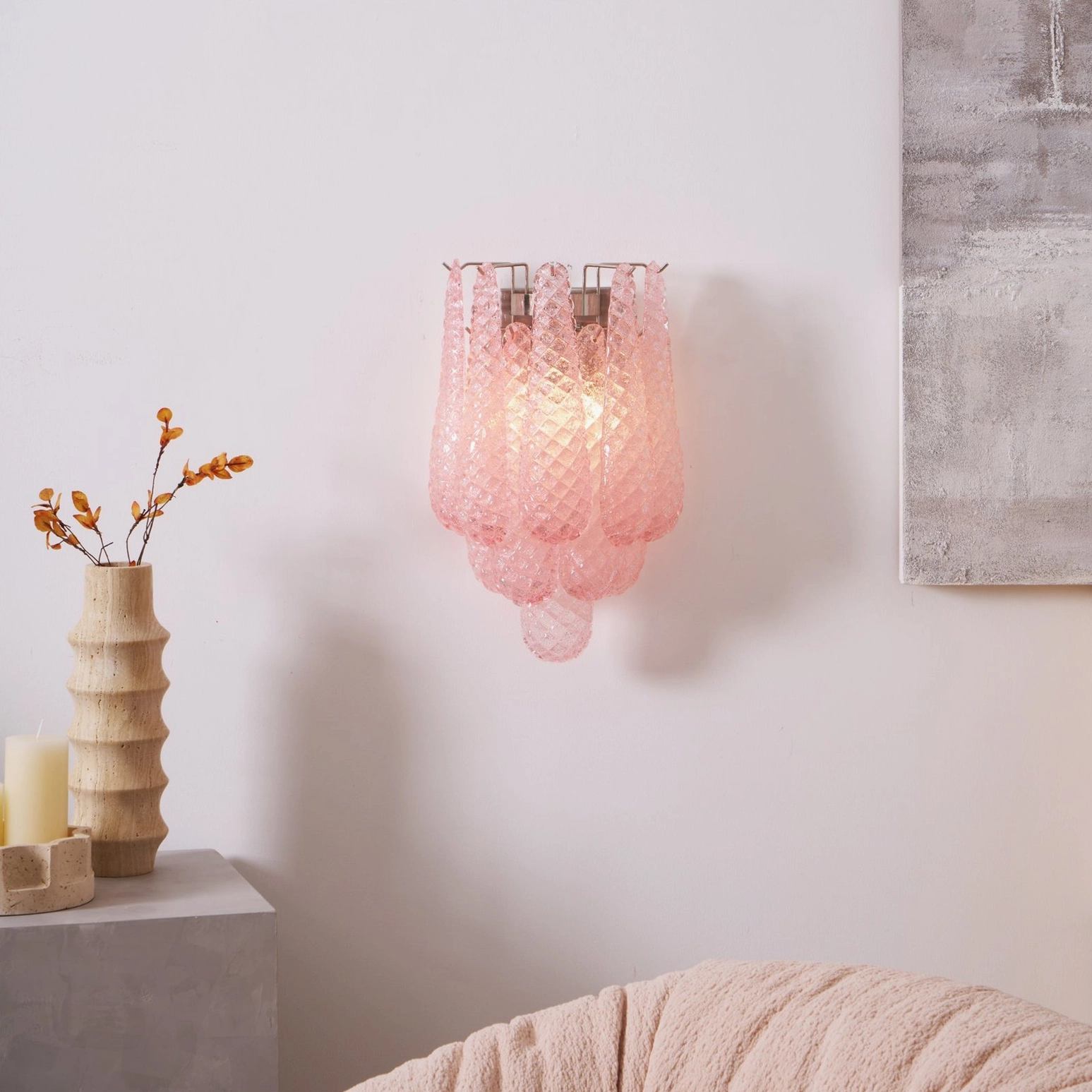 Pink Viola Drop wall sconce mounted in modern living room with decorative wall art