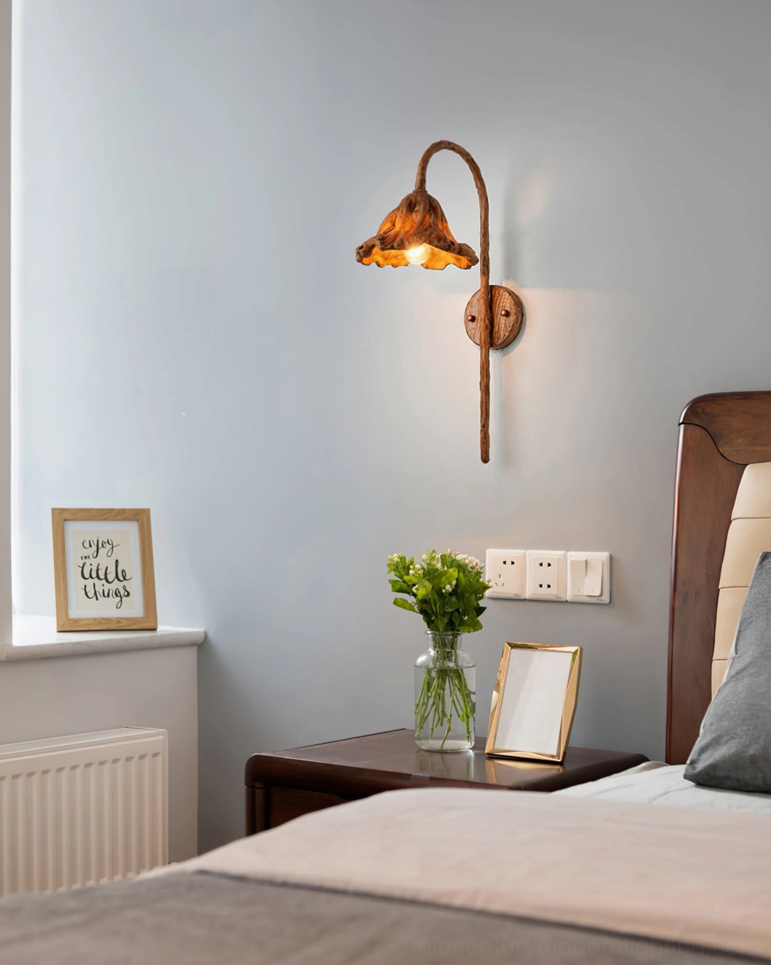 Volcano wall sconce mounted in master bedroom interior beside bedside table with contemporary furnishings