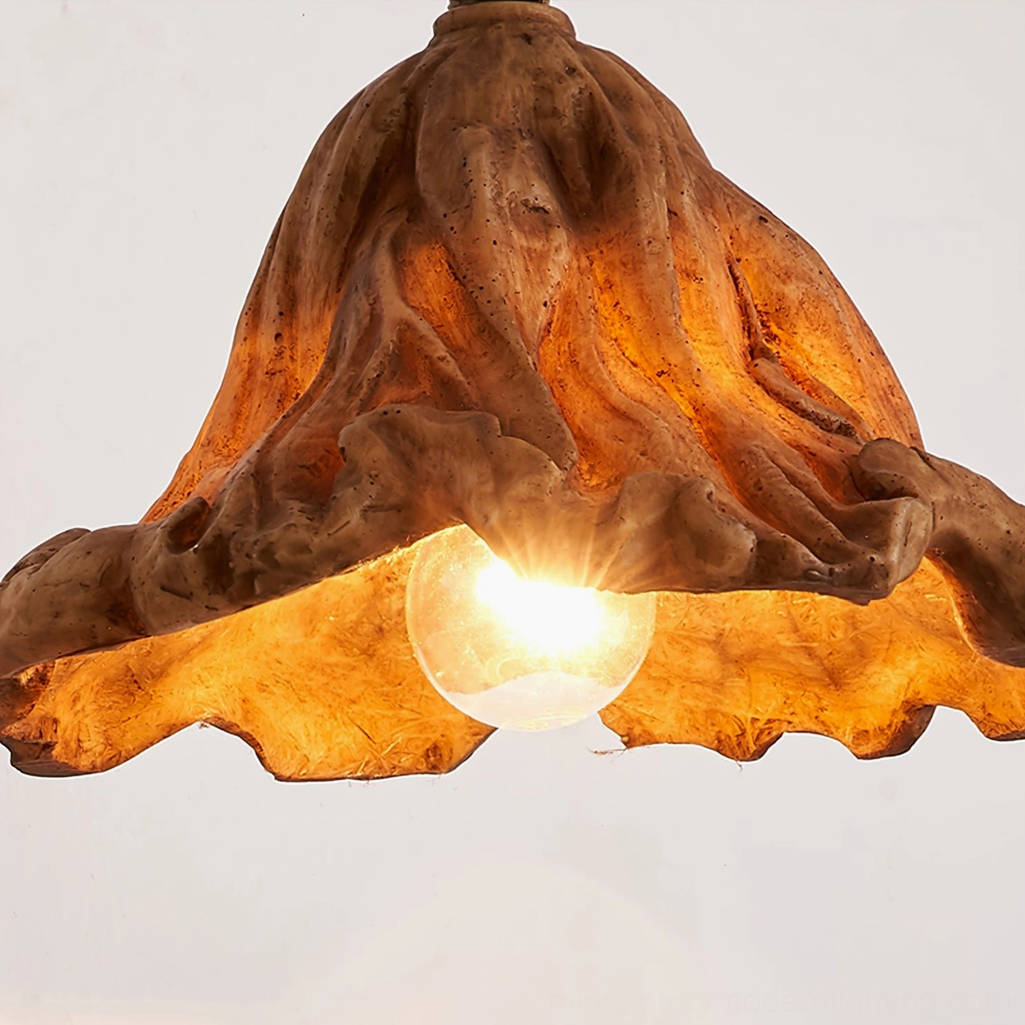 Volcano wall sconce mounted in modern living room interior setting with minimalist white shade and contemporary decor