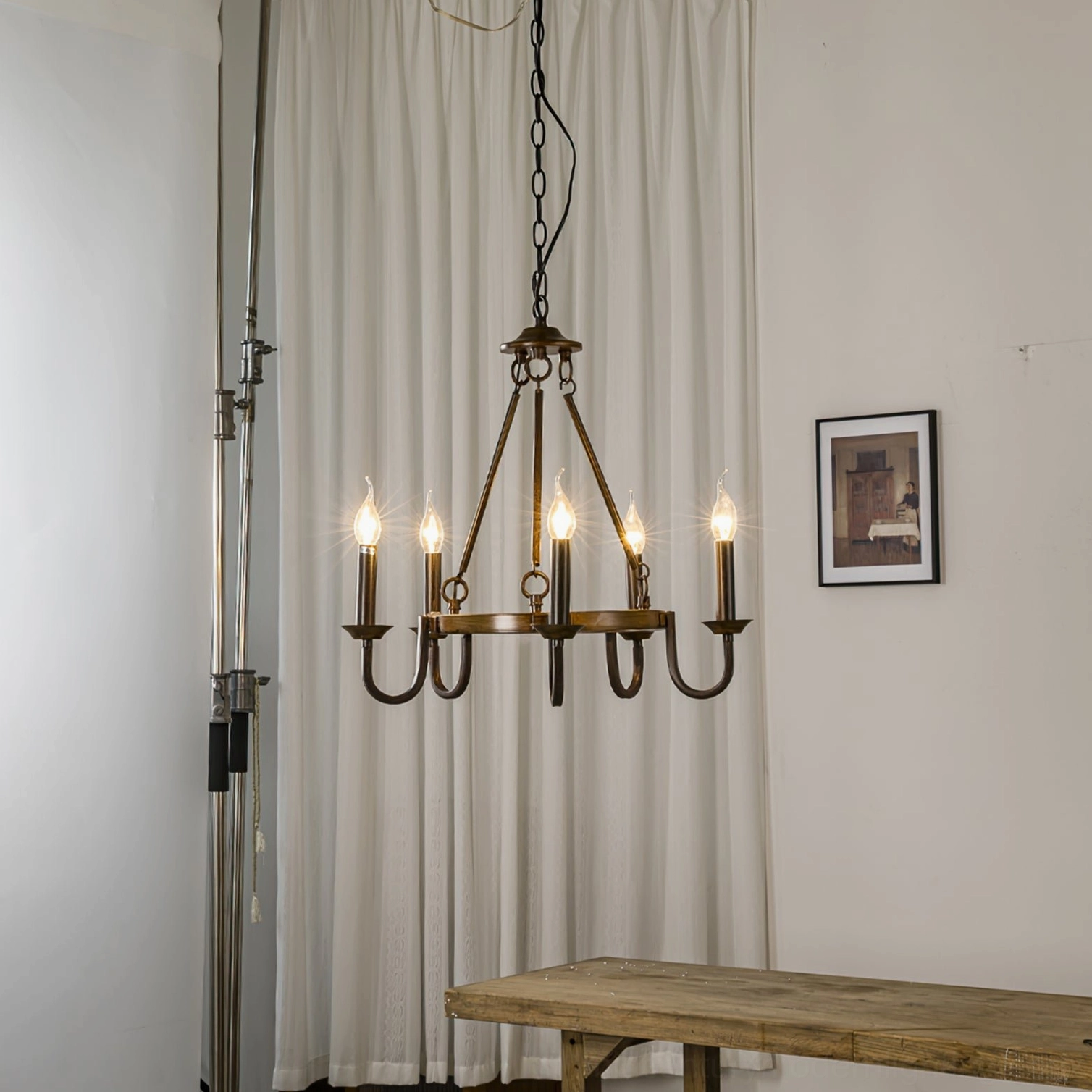 Rustic 5-light wagon wheel chandelier full view wooden table farmhouse decor setting
