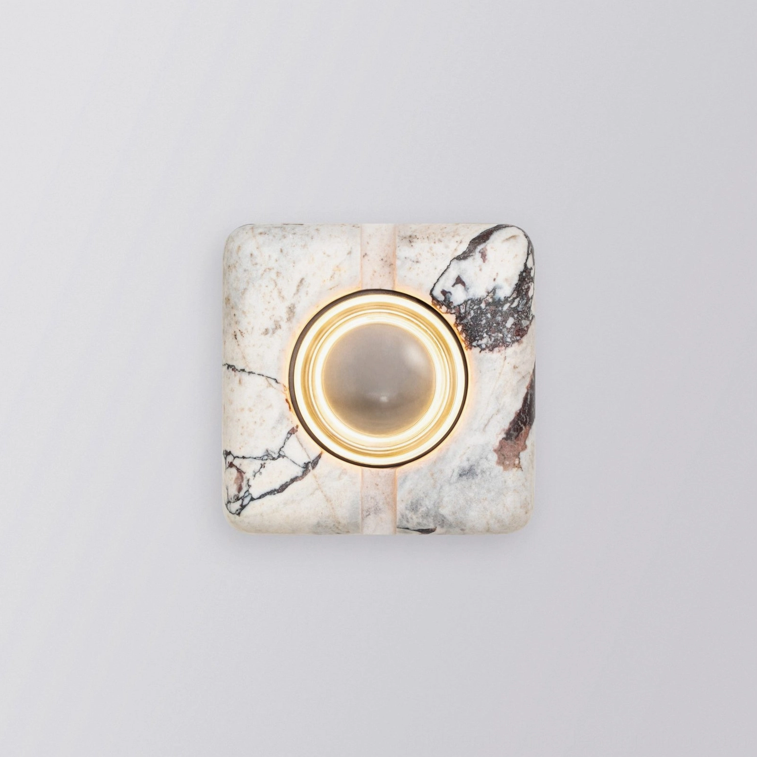 Close-up rectilinear lamp fixture showing polished metal ring and glass trim detail