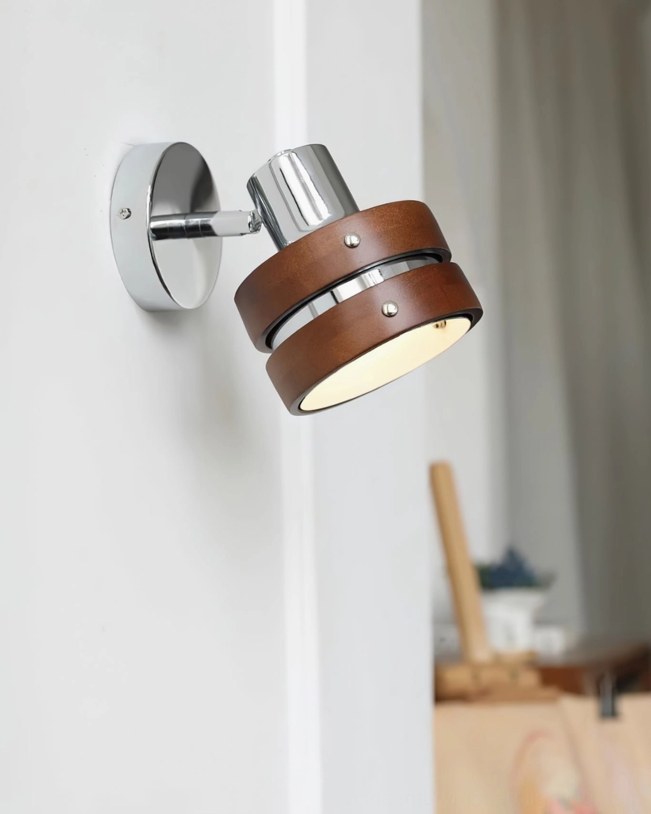 Wall-mounted Nordic sconce with polished chrome and natural wood finish