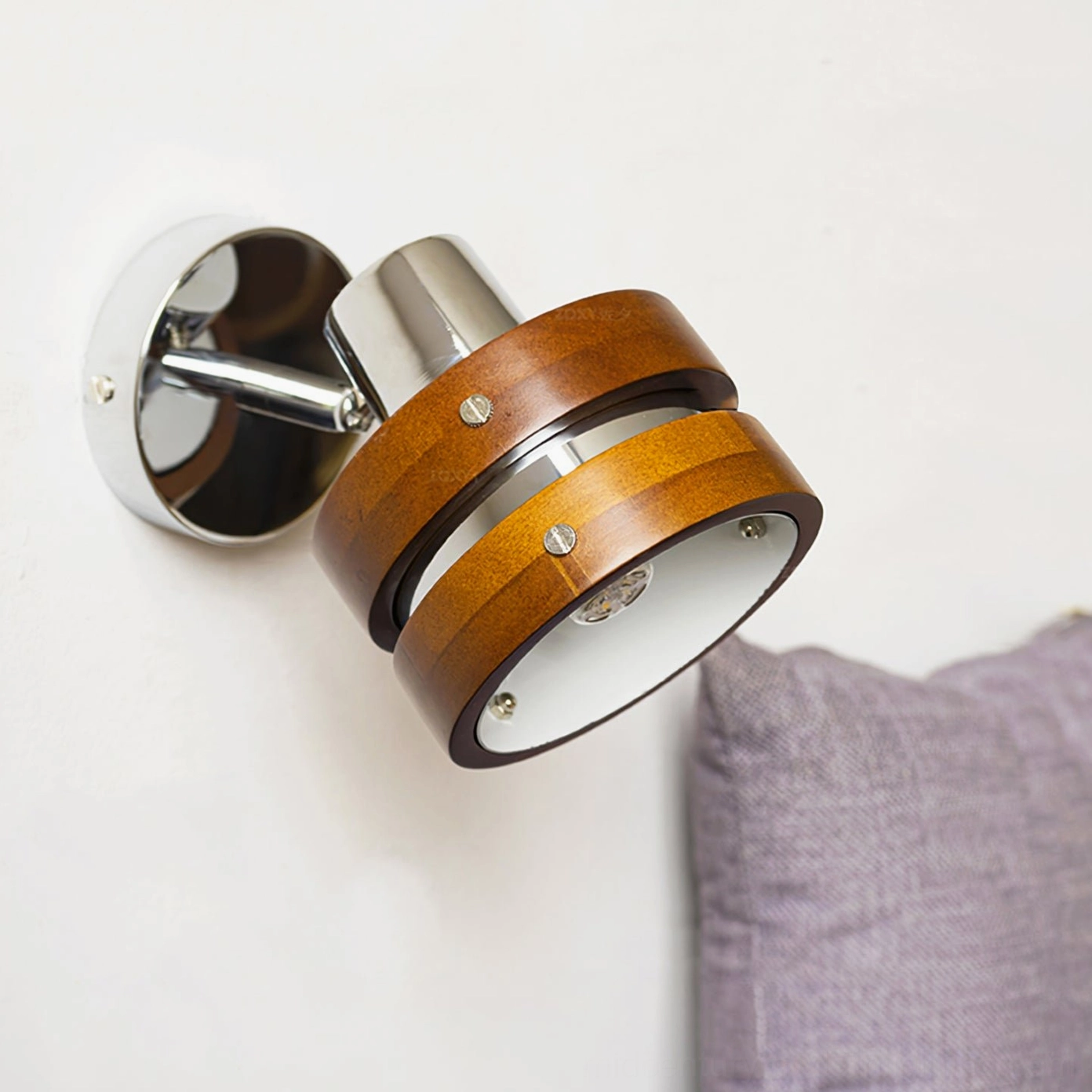 Side view of wall-mounted sconce showing chrome socket and walnut arm detail
