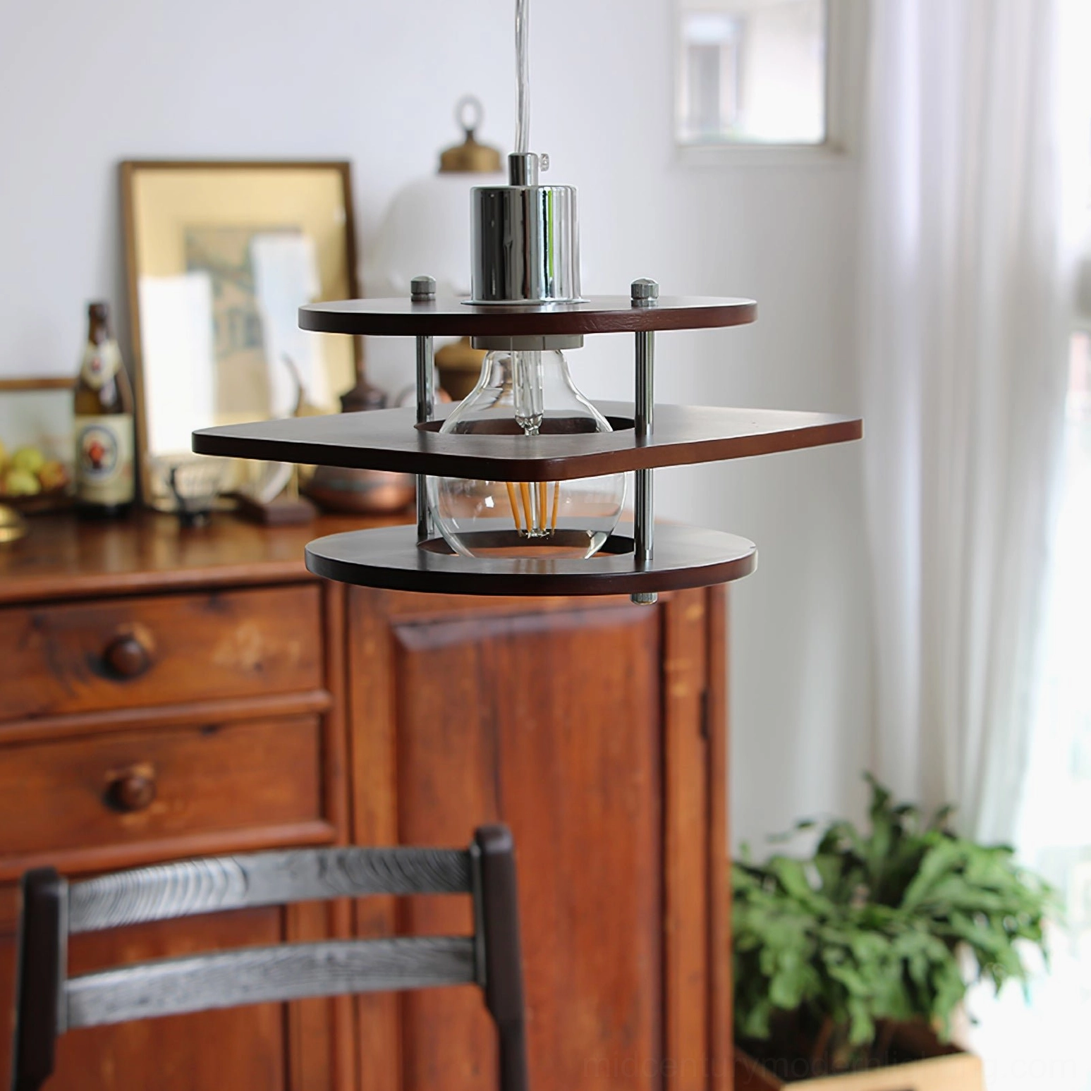 Vintage walnut pendant light with three-tier wood shades and exposed Edison bulb, dining room interior setting