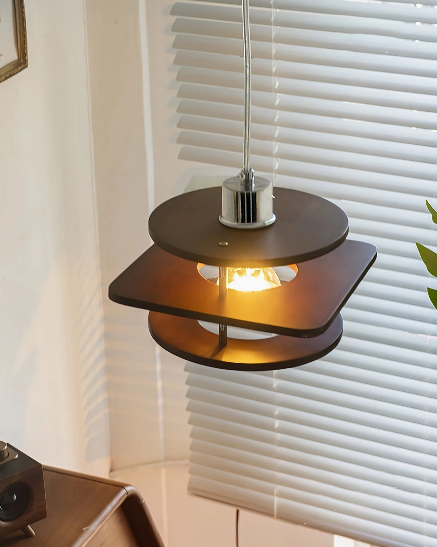 Walnut pendant lamp reversed tiered wood shades with chrome top fixture, unlit frontal angled view