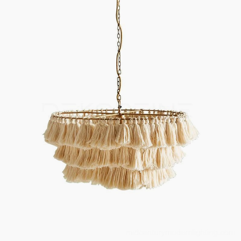 Cream tiered tassel chandelier providing warm diffused light in eclectic bohemian living environment