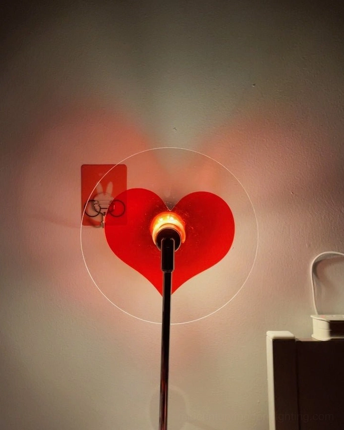 Red heart floor lamp illuminating interior space with warm atmospheric lighting effect