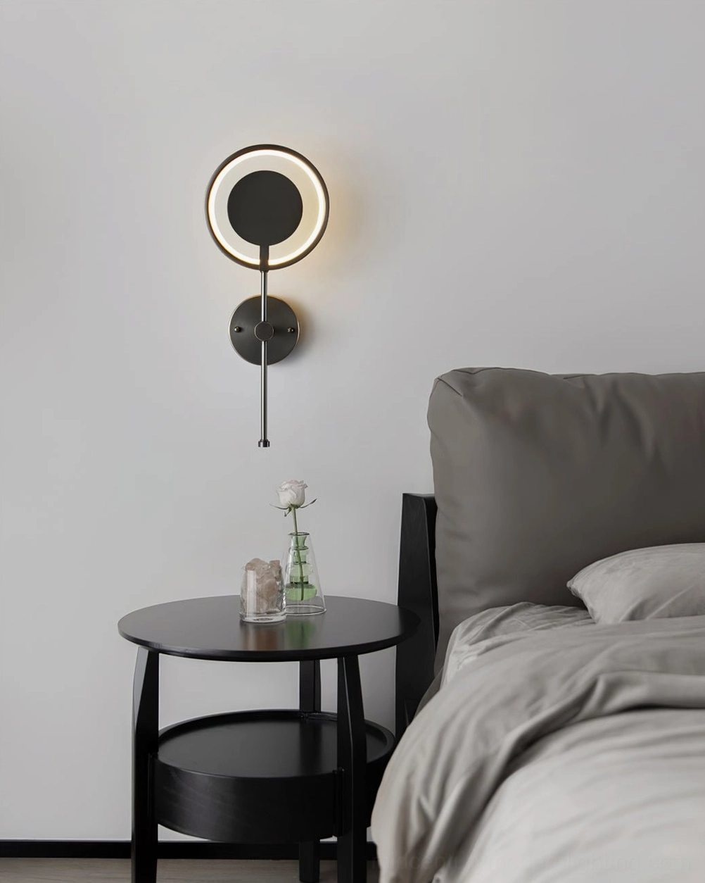 Modern bedroom ambiance with warm glowing ring LED wall lamp illuminating wall and side table area