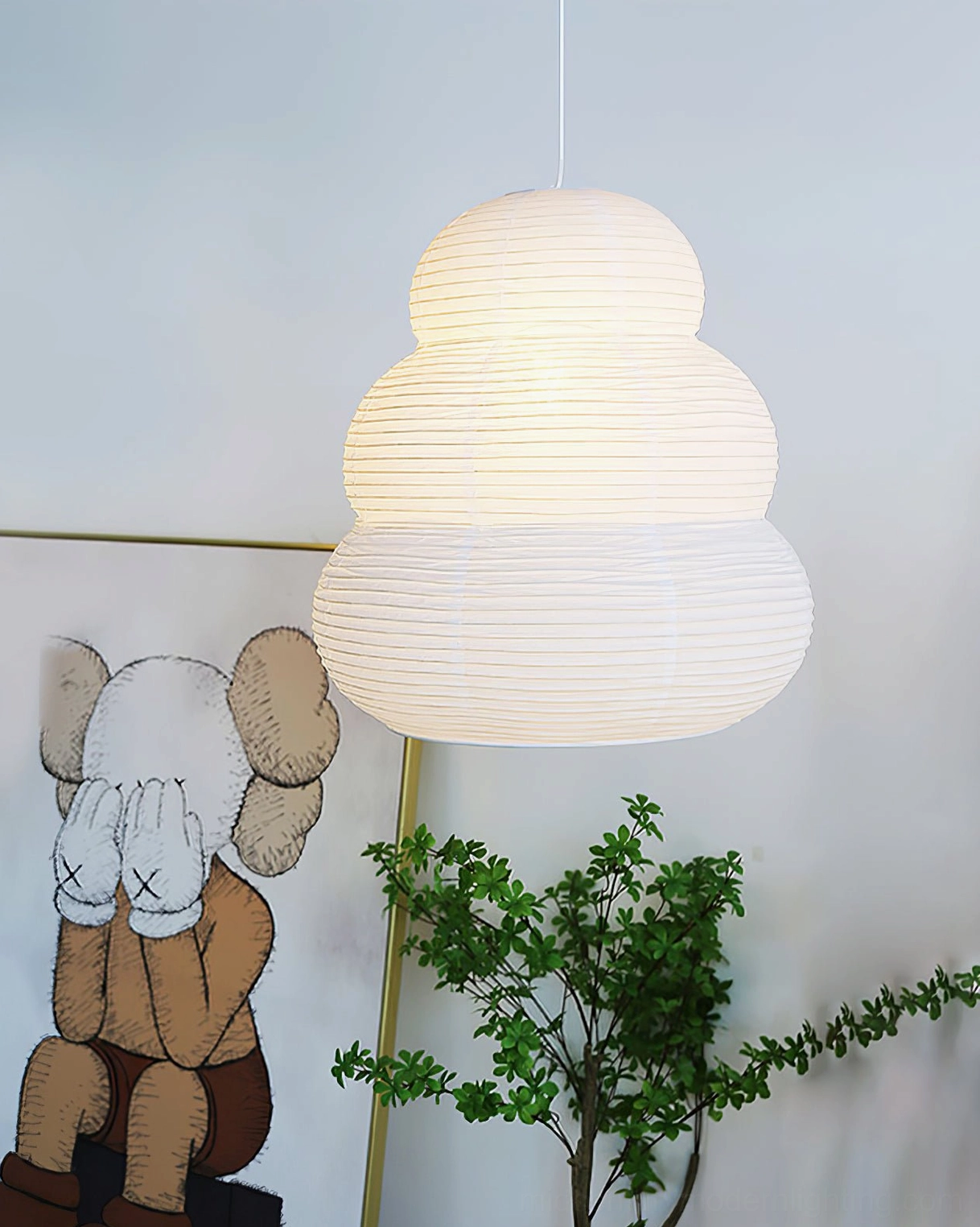 Washi 24N white handcrafted pendant light hanging in decorative home art corner with wall art and green plant