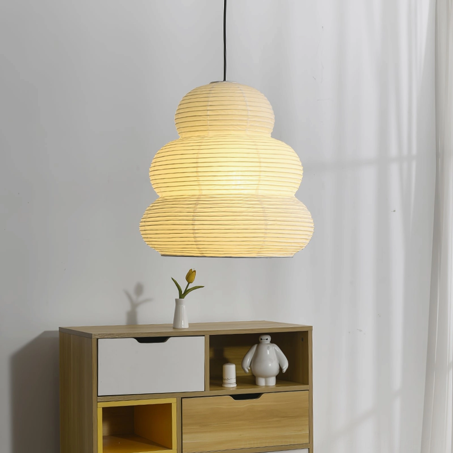 Washi 24N illuminated pendant with warm glow in minimalist home corner with tabletop decor and styling