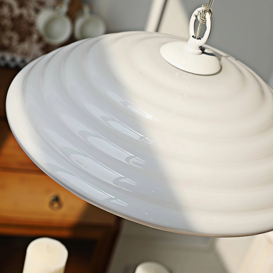 Wave pendant lamp top-down close-up view showing swirling ribbed texture pattern and glossy white finish with metal hardware