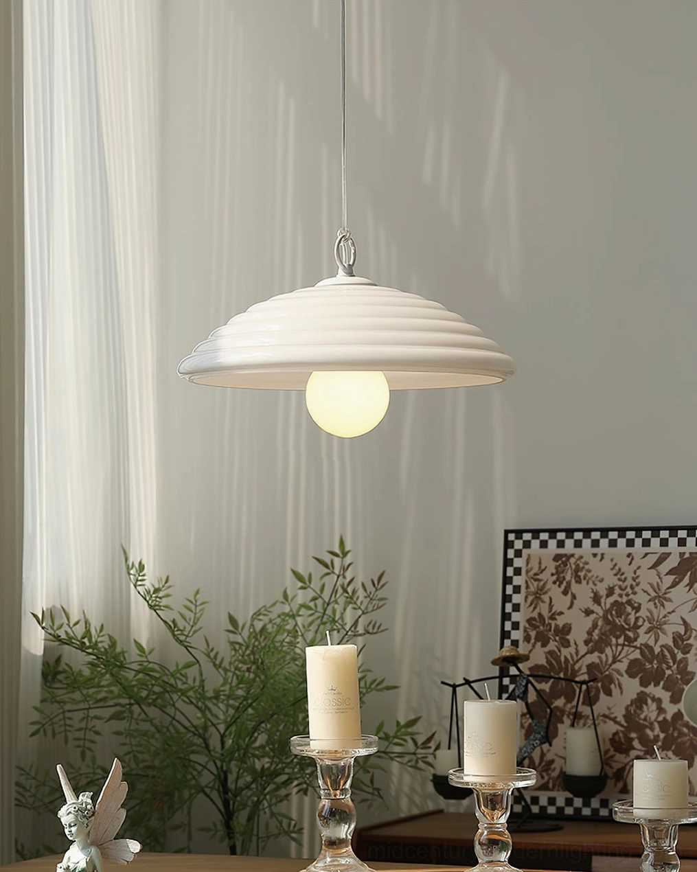 Wave modern pendant with white ribbed glass dome shade hanging in minimalist indoor space above tabletop furniture