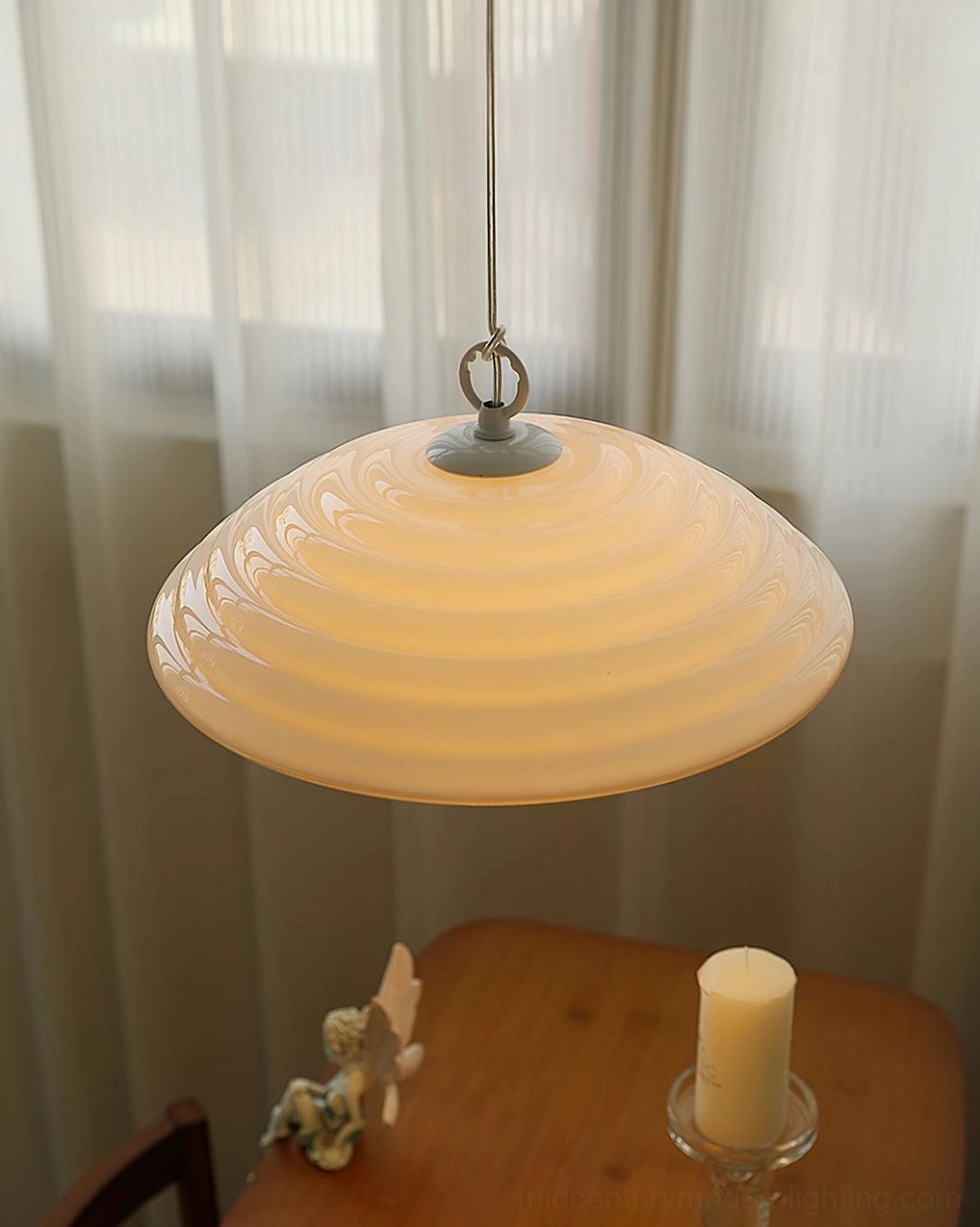 Wave pendant light bottom view showcasing glossy yellow-toned ribbed glass dome and curved architectural details