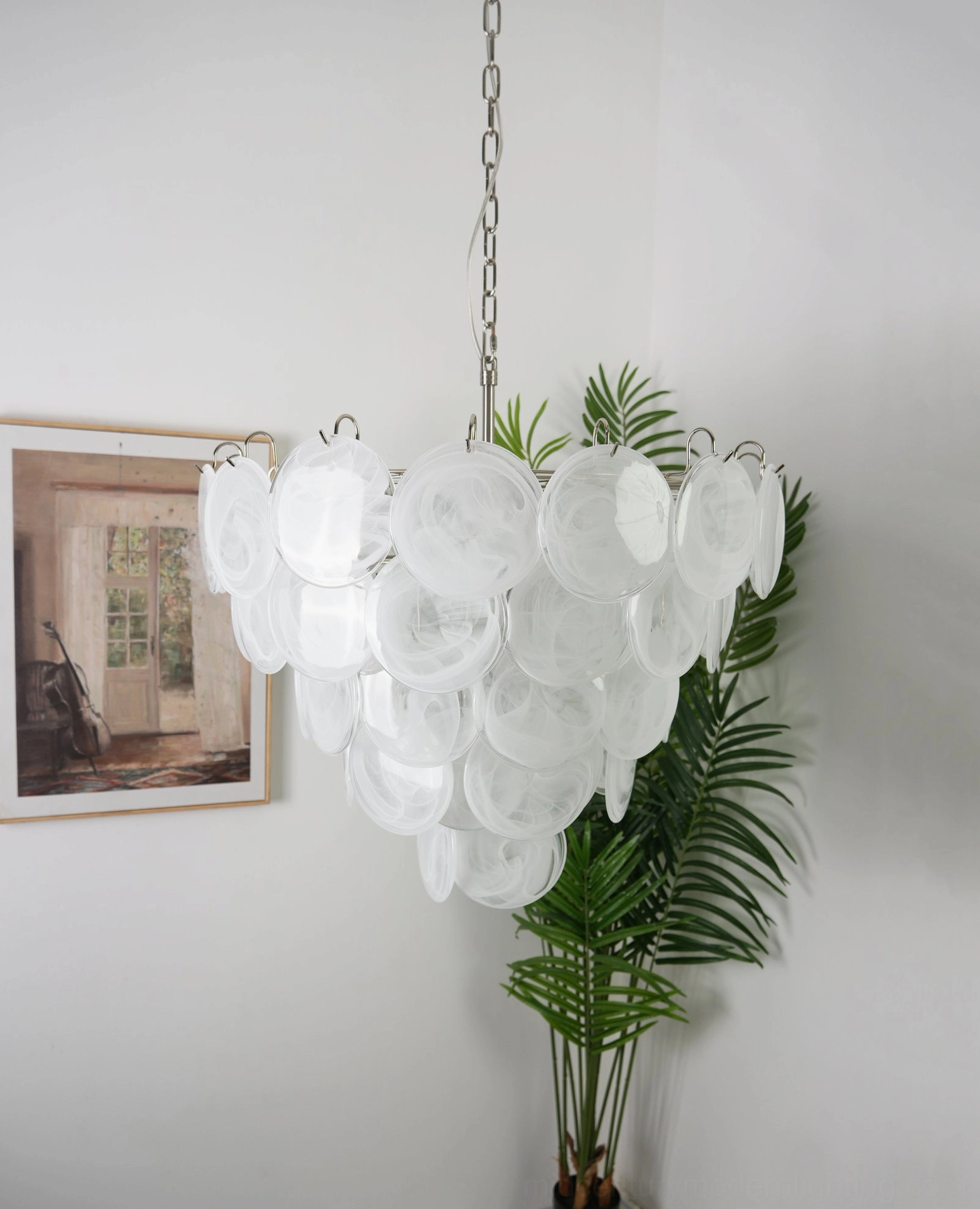 White glass disc chandelier creating light refraction and shadow depth effect, mid-century modern home interior display