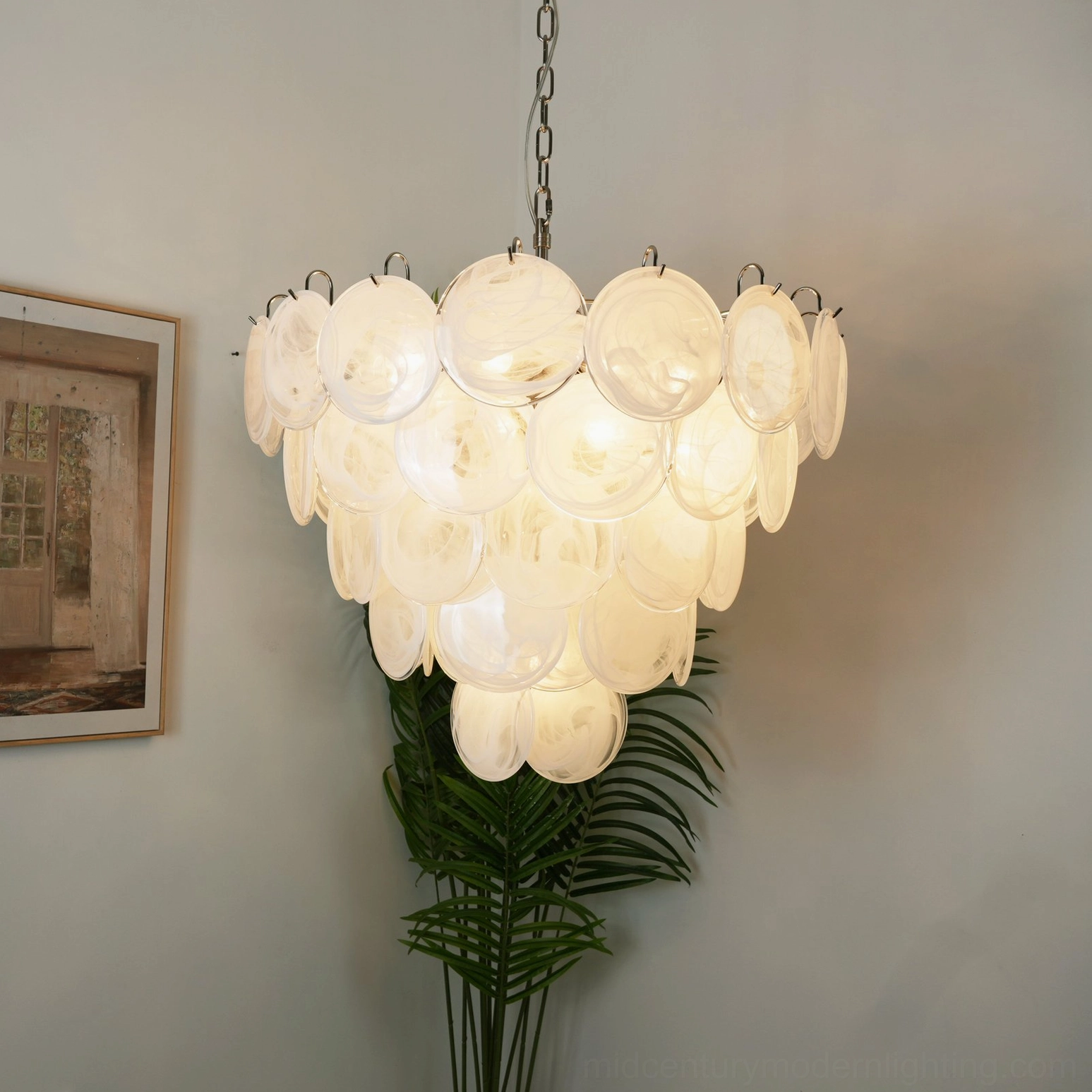 White Murano disc chandelier showing reflective glass surfaces creating light refraction effect, modern minimalist home setting