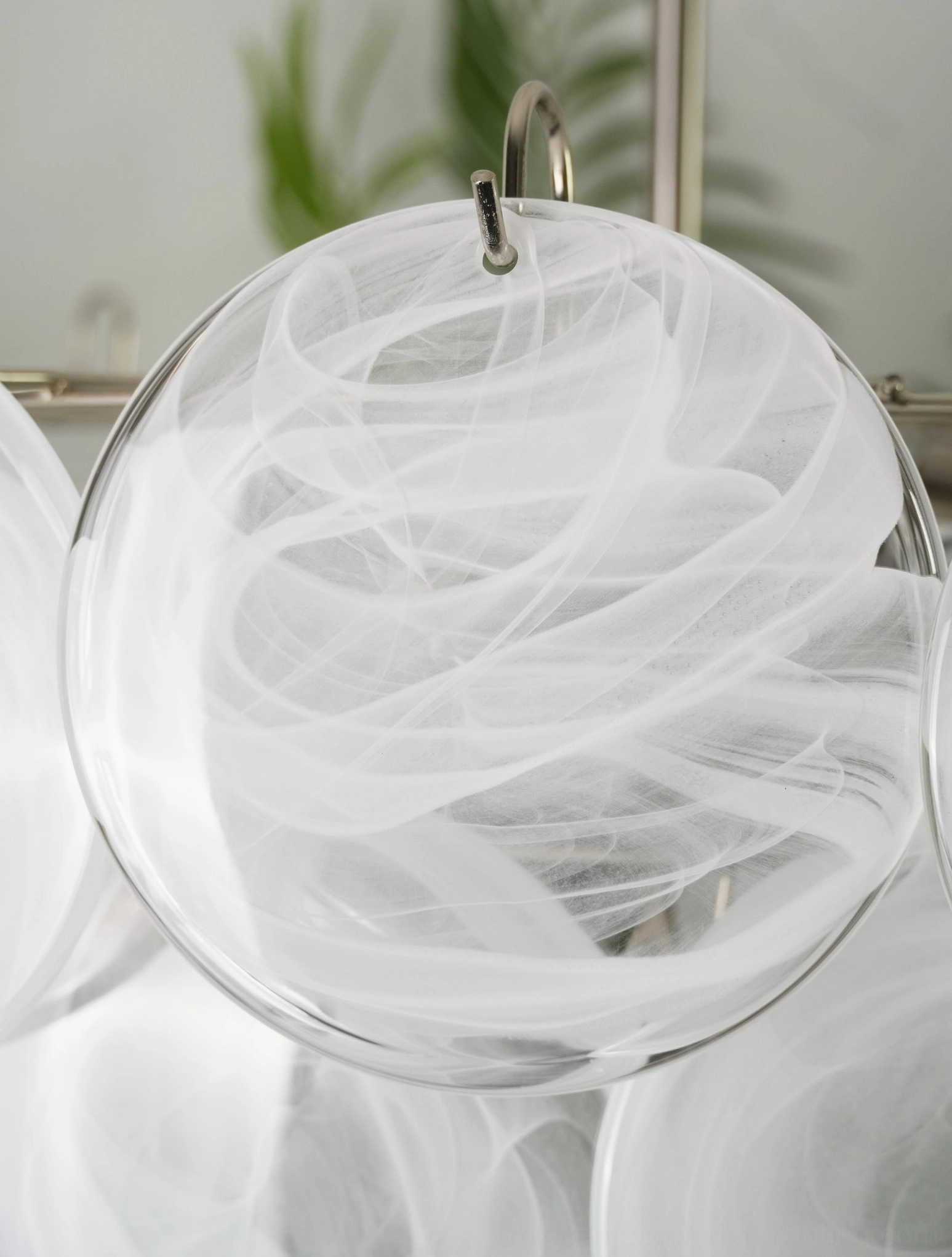 White glass disc chandelier with translucent round discs stacked in conical formation, contemporary home interior three-quarter view