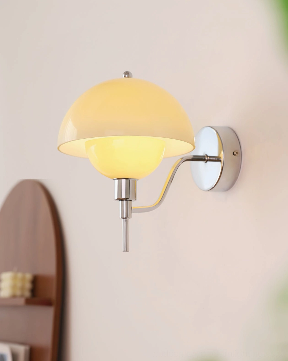 White anchored orb wall lamp with metal fixture mounted in minimalist modern home environment