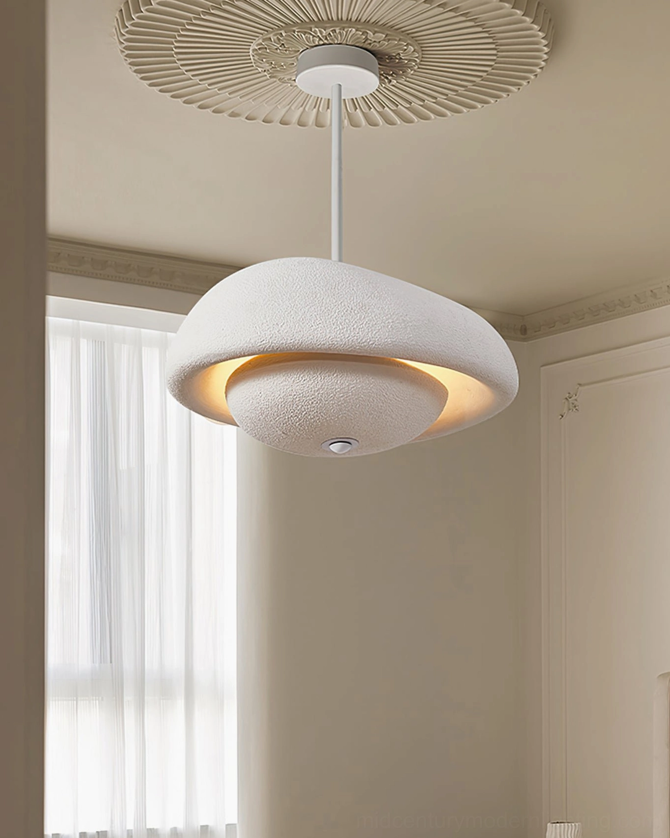 Off-white organic cloud pendant lamp in bright bedroom with sheer curtains and soft natural light