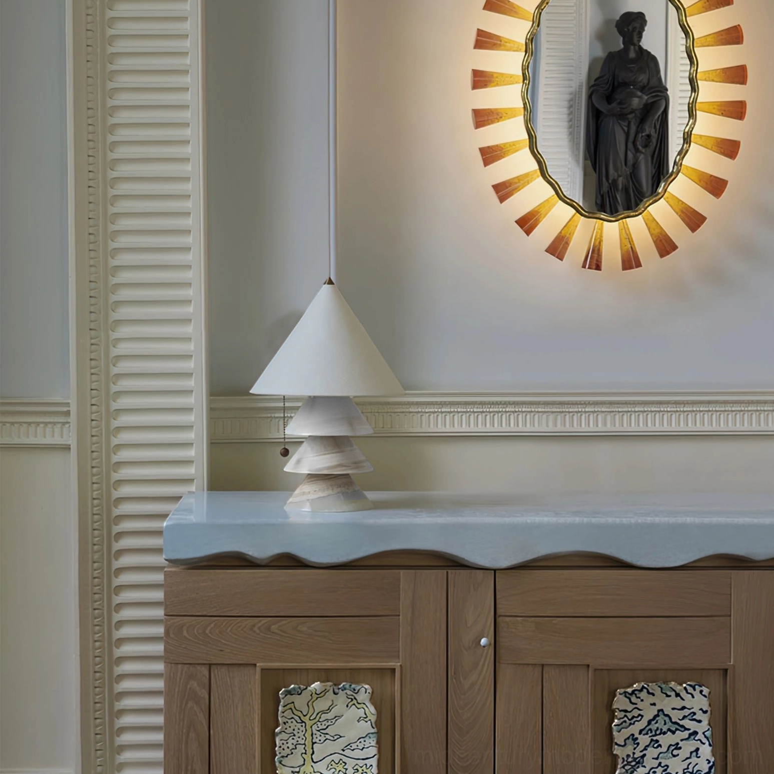White marble pyramid lamp with fabric shade on wooden console in luxury residential entryway