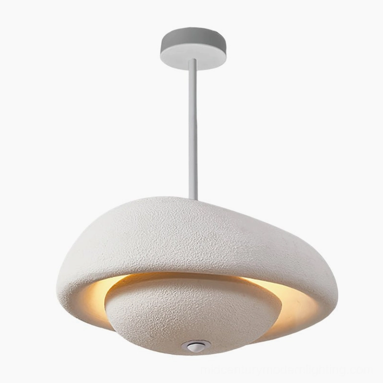 White sculptural pendant light installed as focal point in minimalist interior space