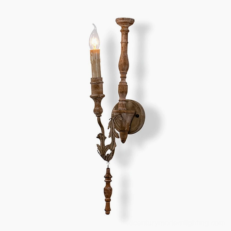 Brown distressed wall sconce with ornate carved details and dual lighting arms