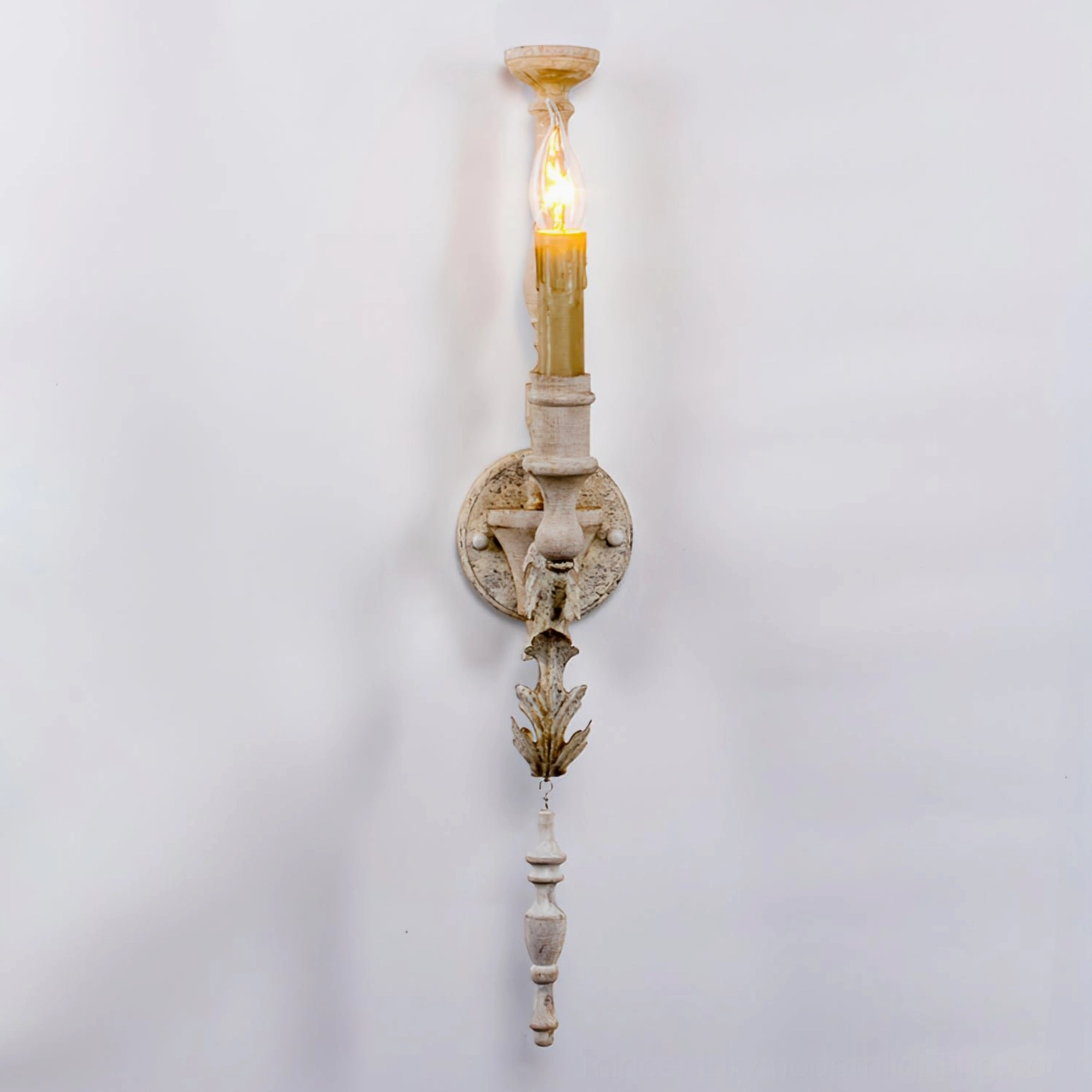 Single-armed vintage wall sconce with carved leaf decor and turned wooden hanging detail
